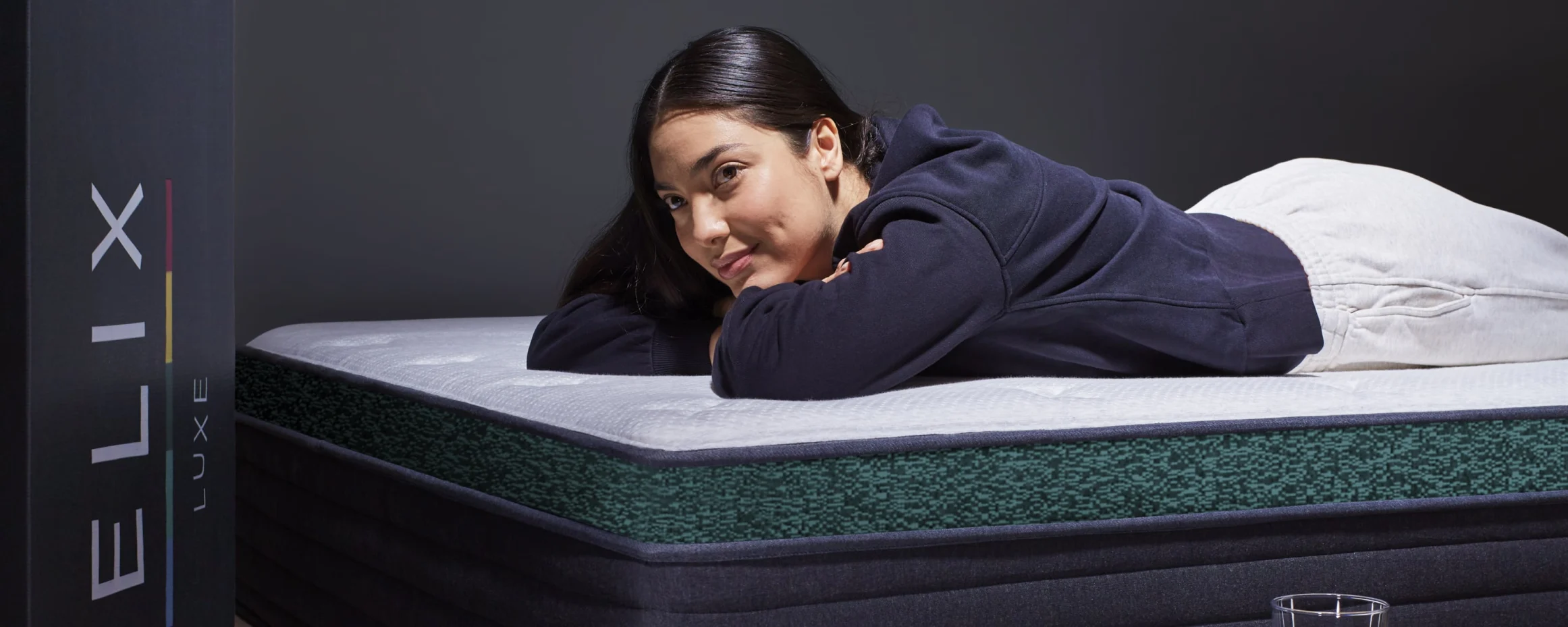 A woman lies on a Helix Twilight Luxe mattress