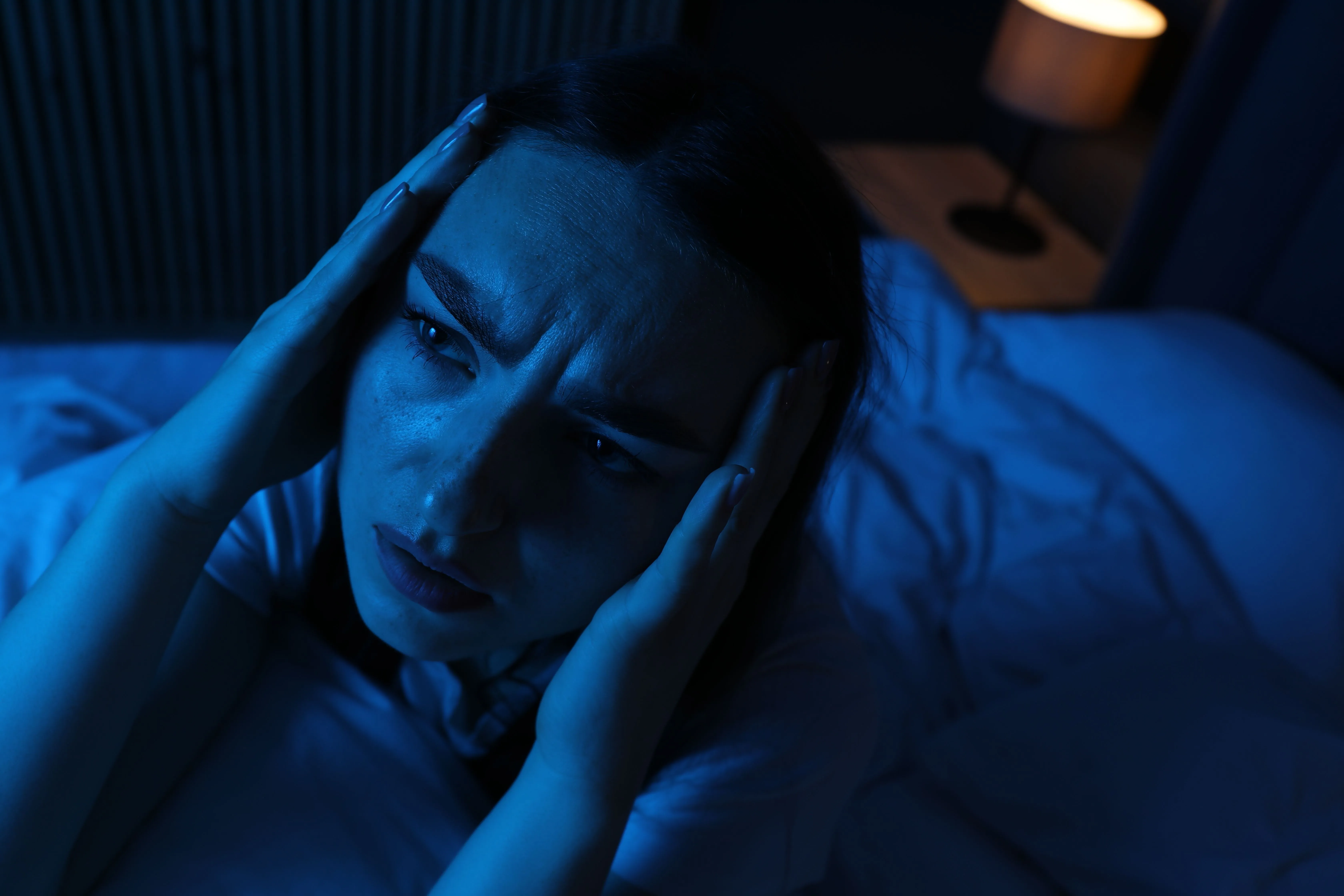 Woman awake in bed during the early morning