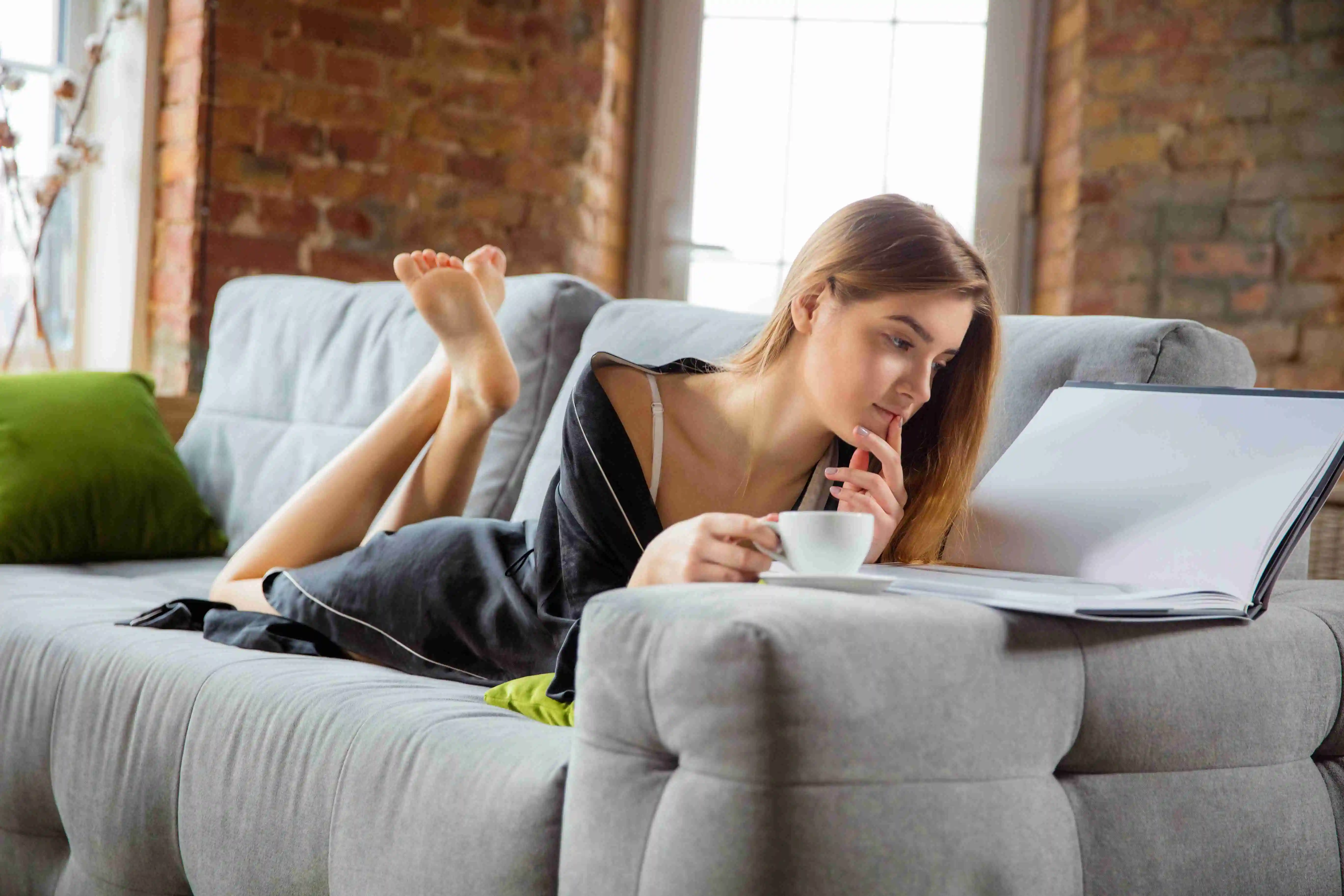 Woman wearing silk robe doing her daily skincare routine at home