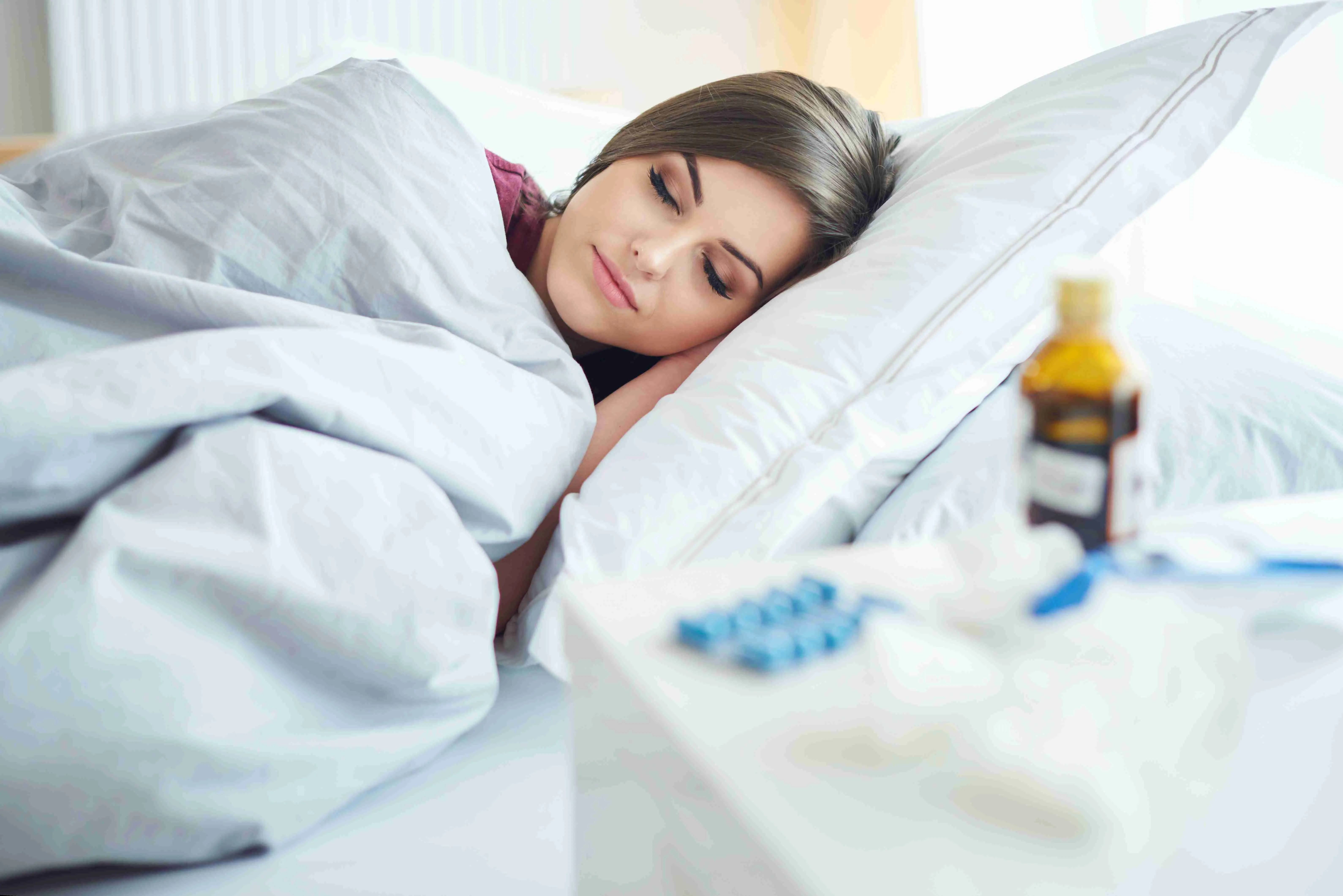 woman lying under the duvet