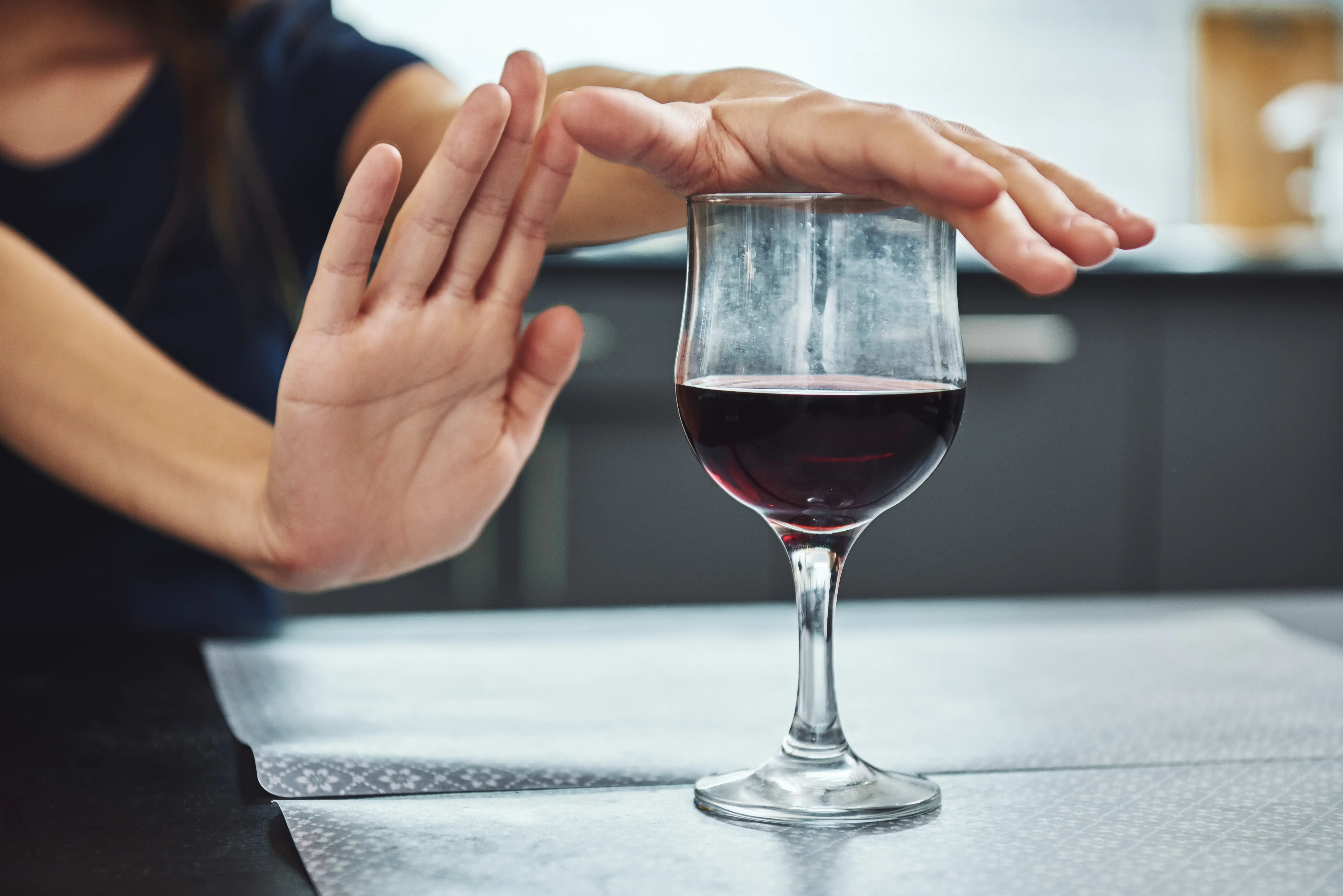 Addicted woman refuses to drink a glass of red wine