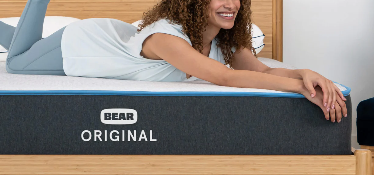 reviewer laying on Bear Original mattress