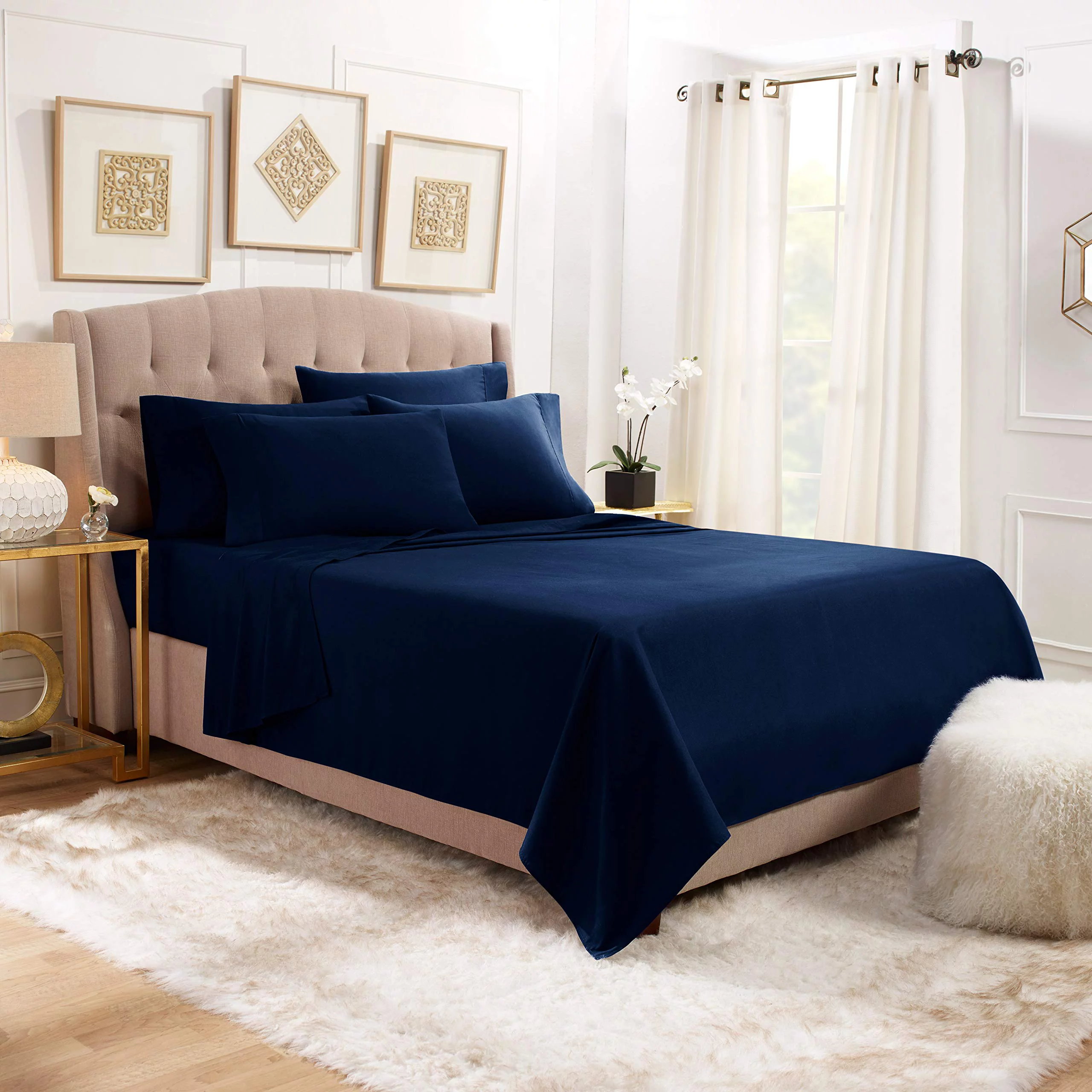  Blue duvet and pillows on a dark wood bed frame.