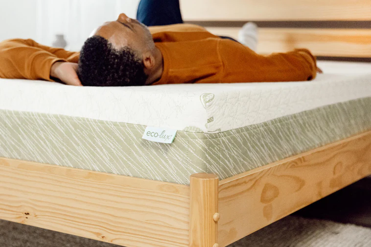 A reviewer sleeping on BedInABox Eco-Lux mattress