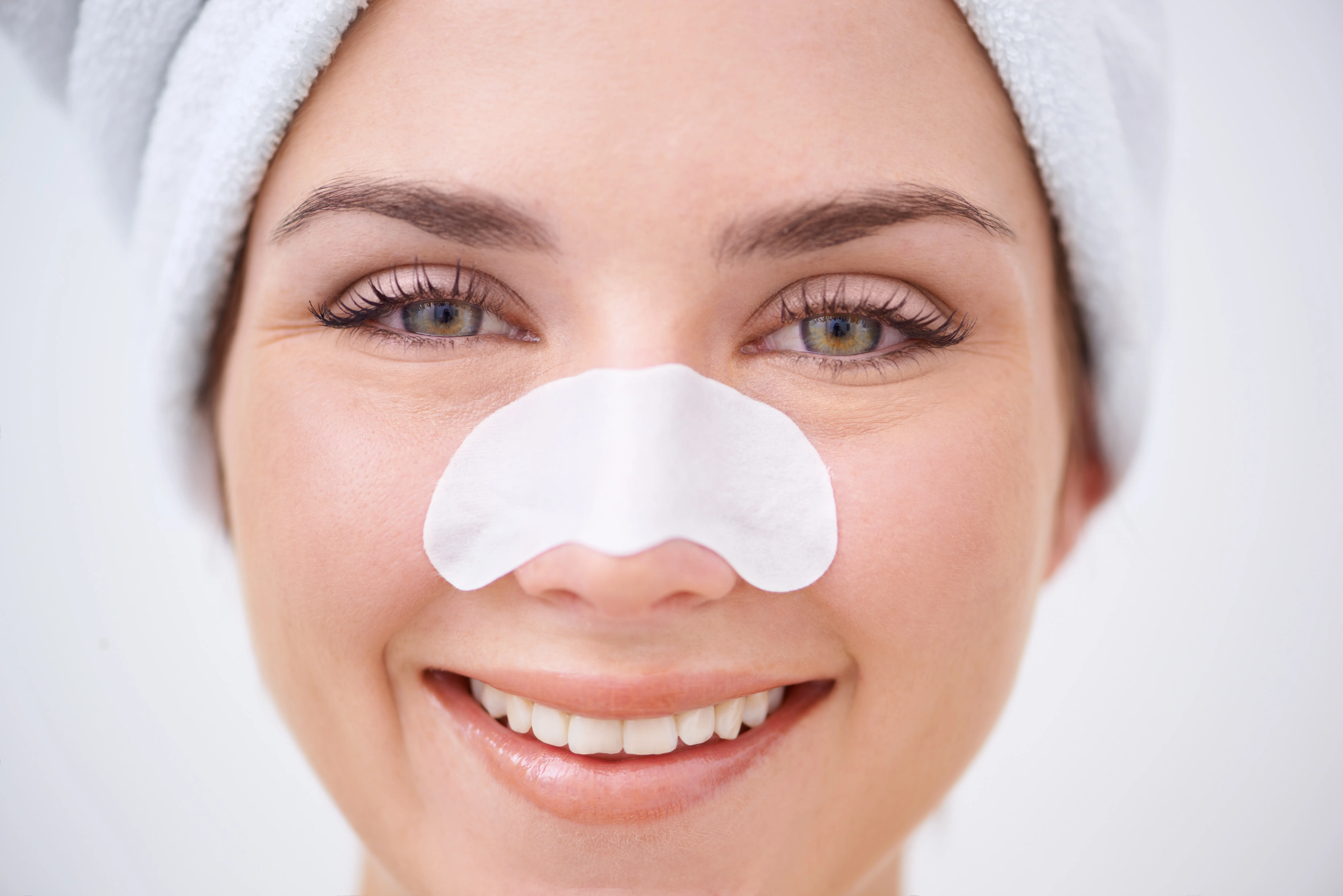 A young woman with a nose strip on