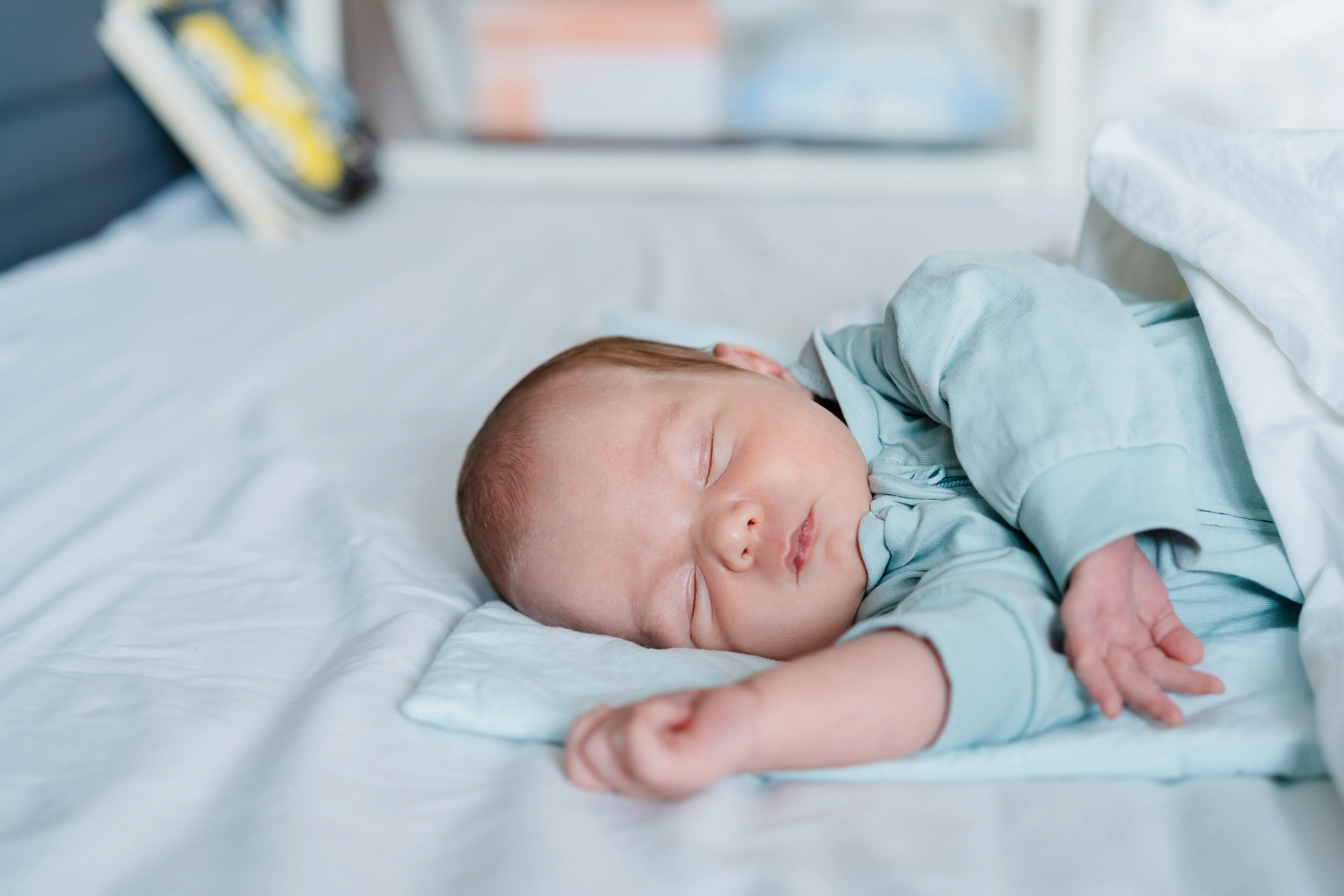 Sleeping Infant Peacefully Resting in Light Blue Clothes