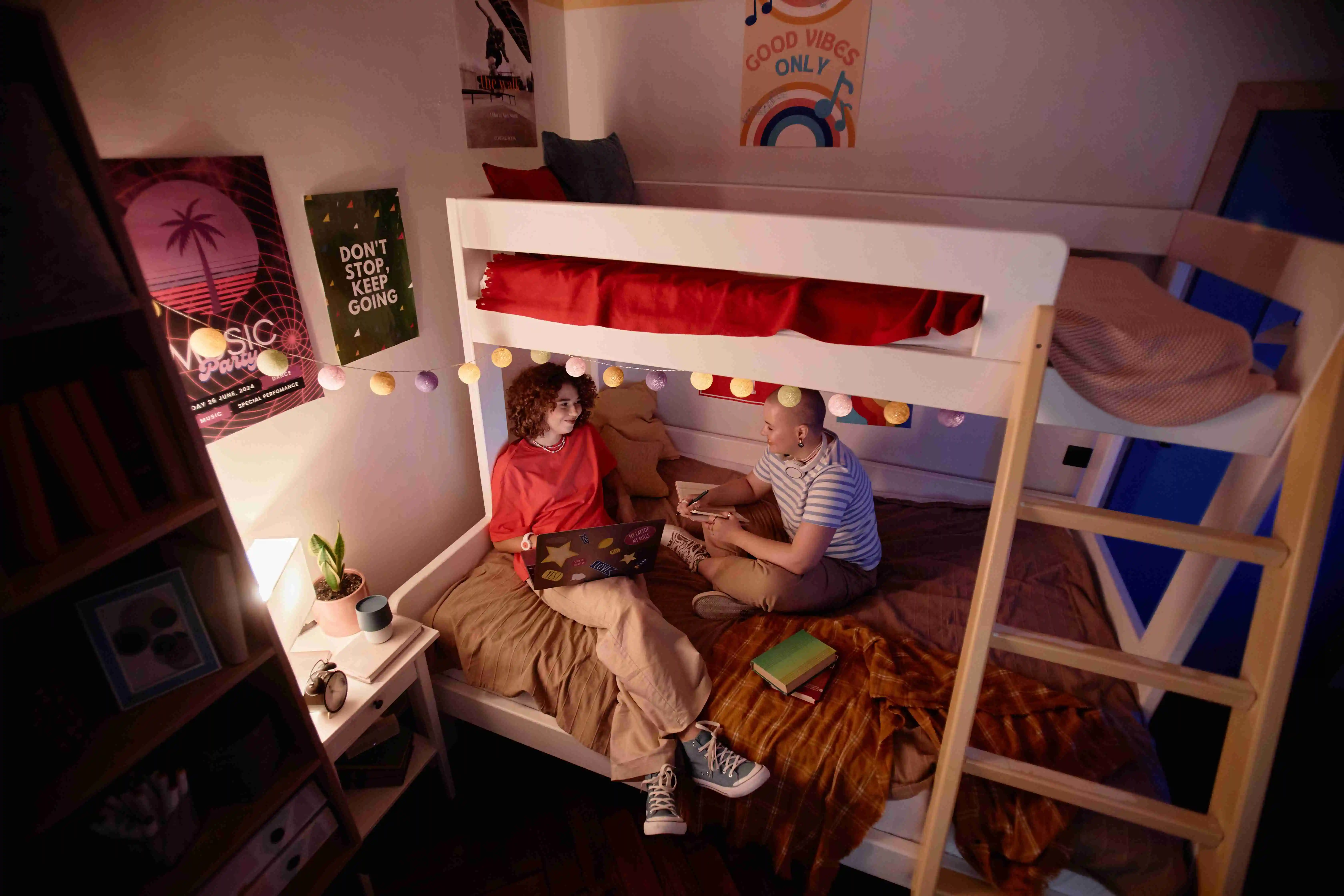 Two Young Students Doing Homework Together on Bunk Bed