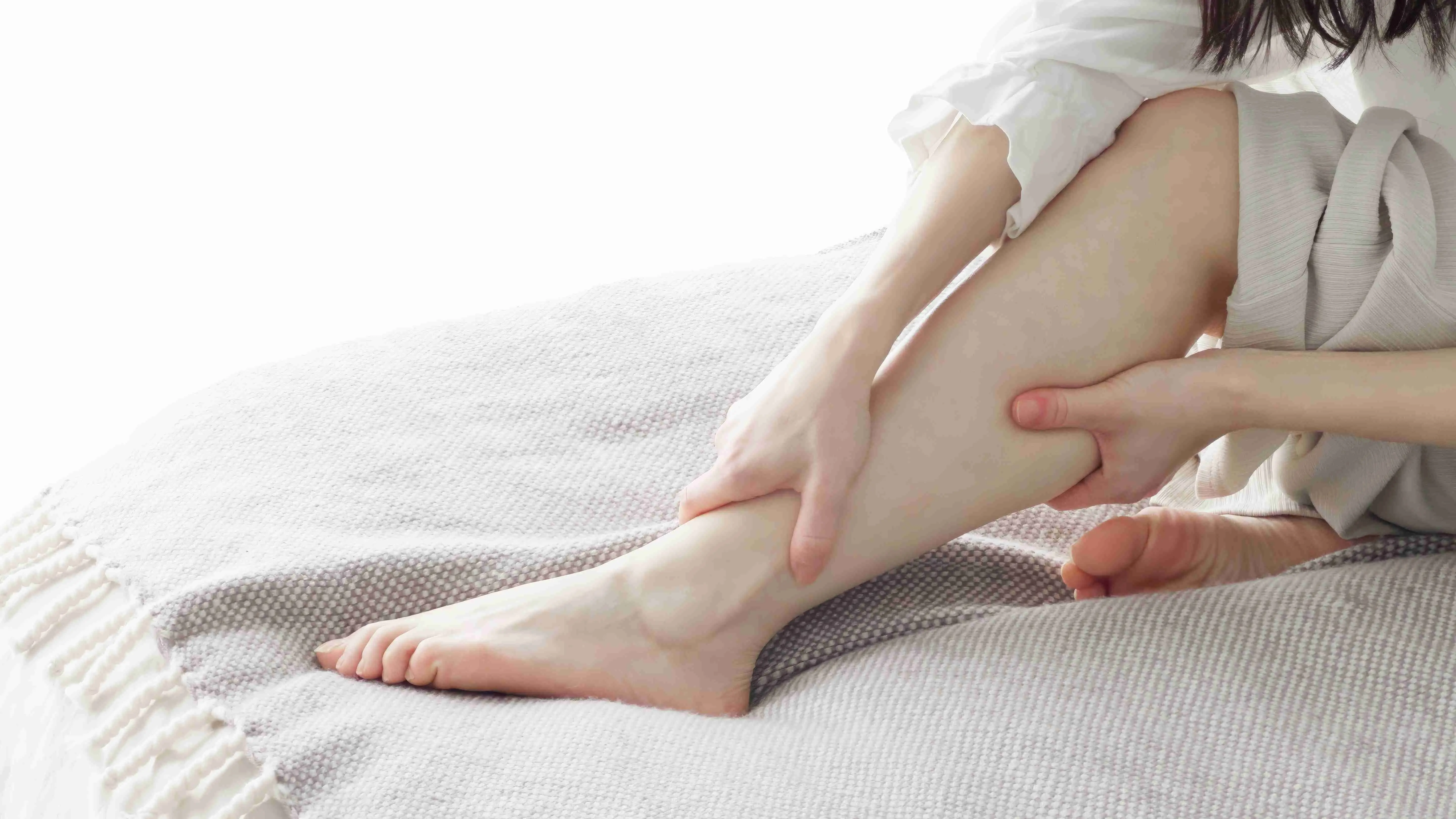 A woman massaging her swollen feet