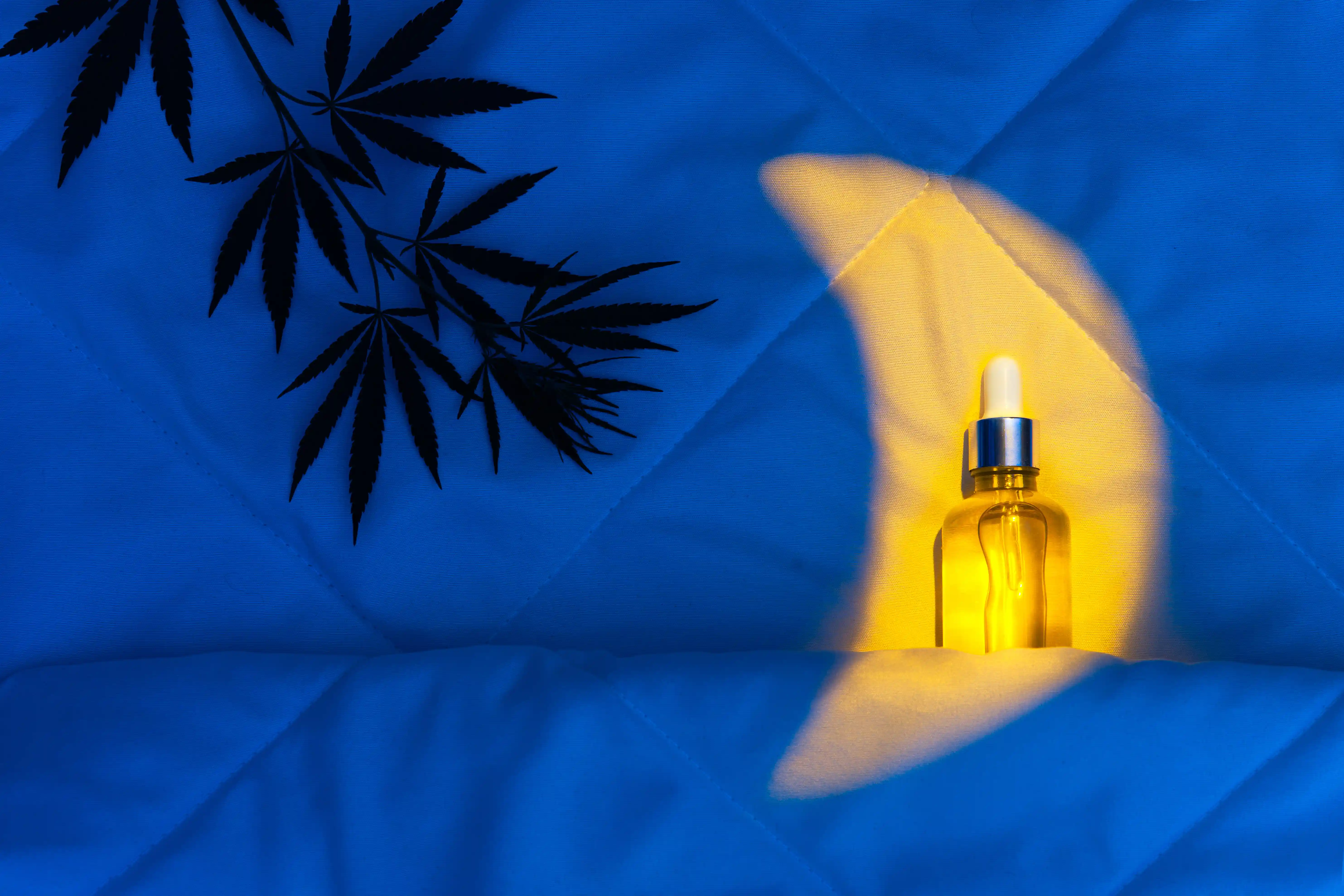 CBD oil and capsules arranged on a bedside table