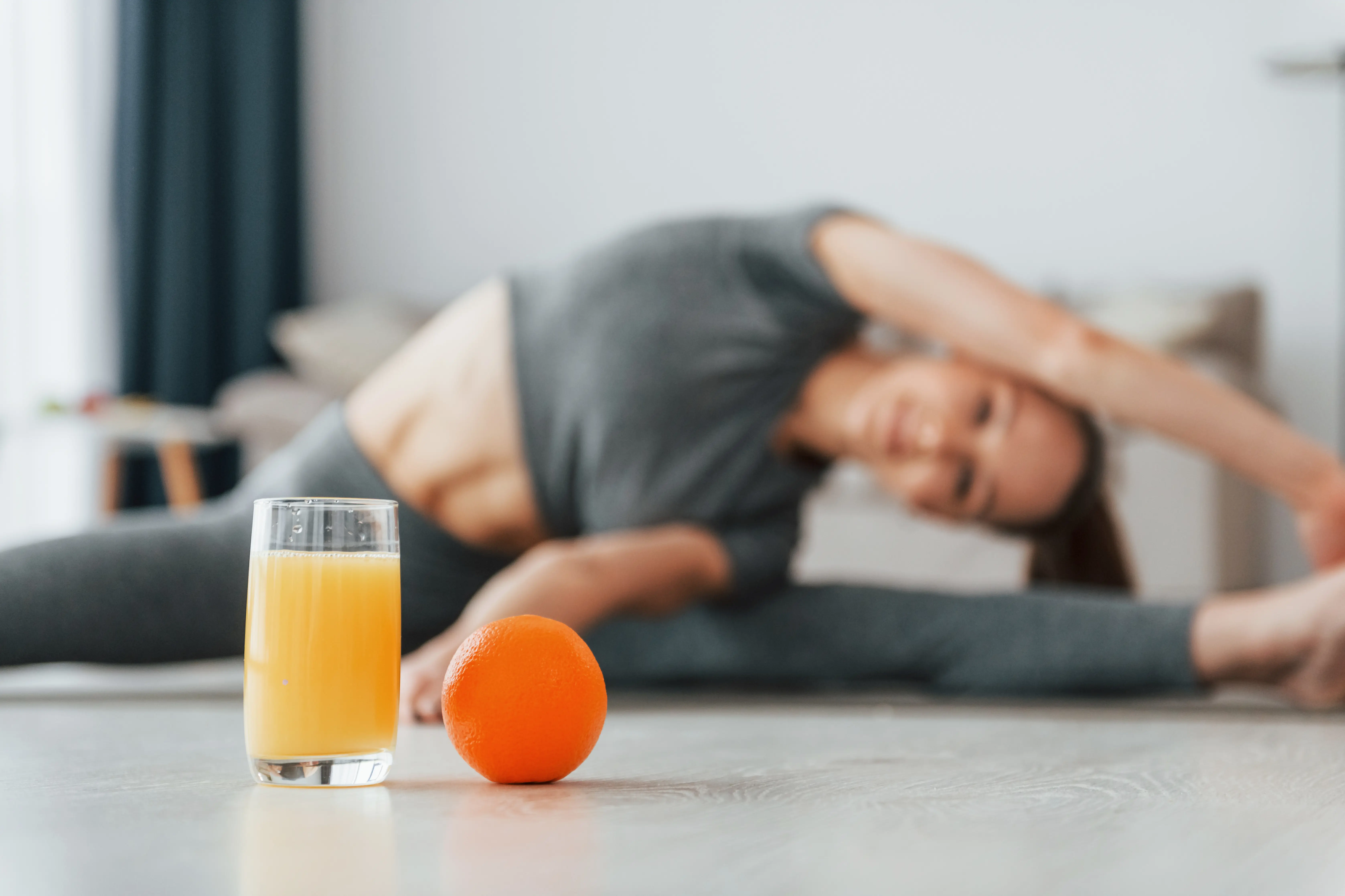 Healthy eating. Young woman with slim body type and in yoga clothes is at home.