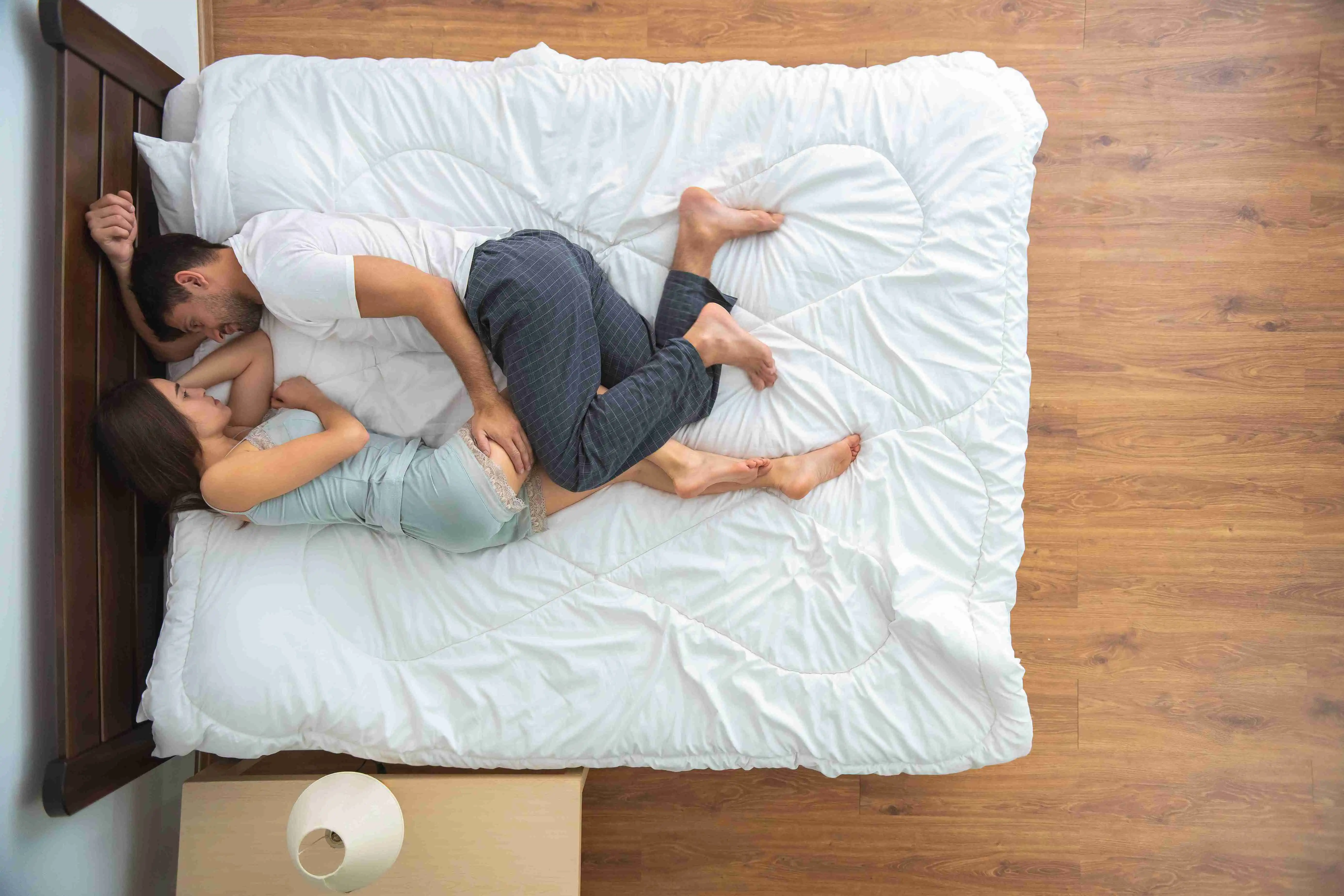 The couple laying on the bed. view from above