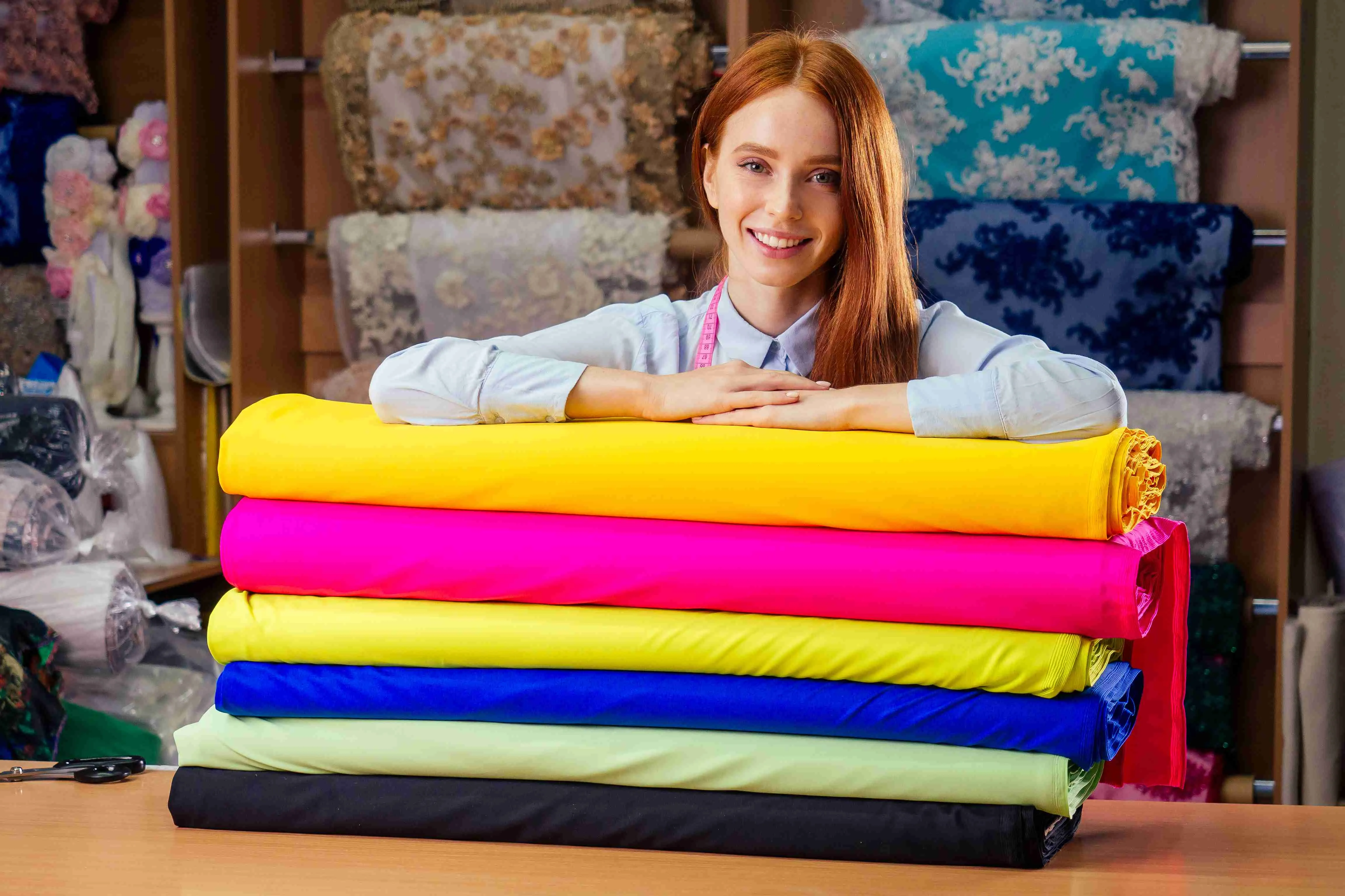 redhaired ginger business woman working at textile shop.