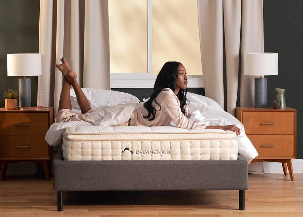 woman comfortably lying on DreamCloud Hybrid Mattress