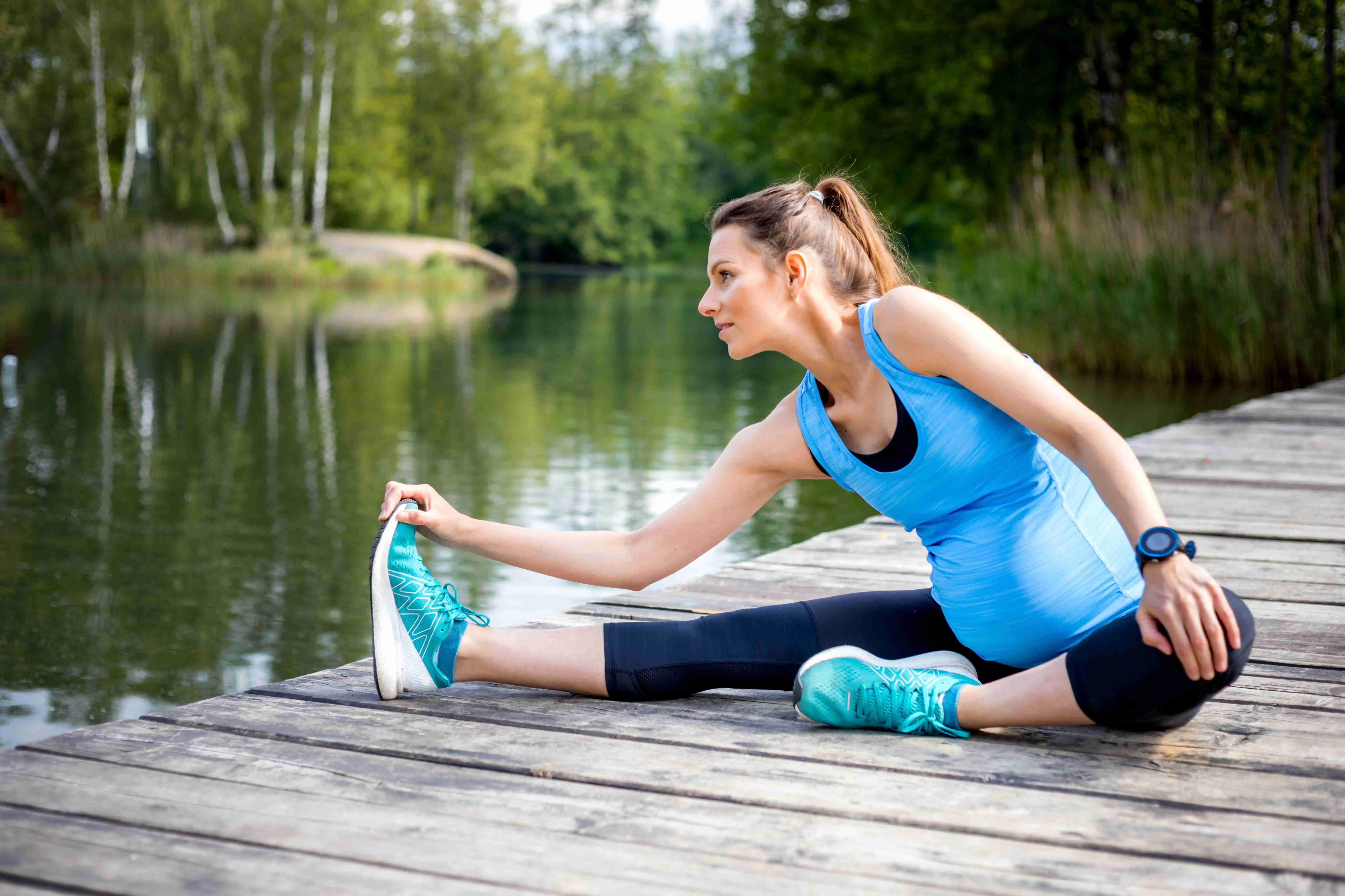 Pregnancy exercise, pregnant woman stretching outdoor