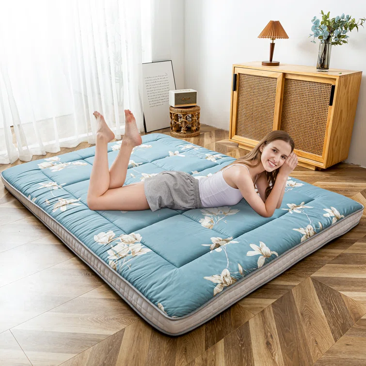 a reviewer laying on futon mattress