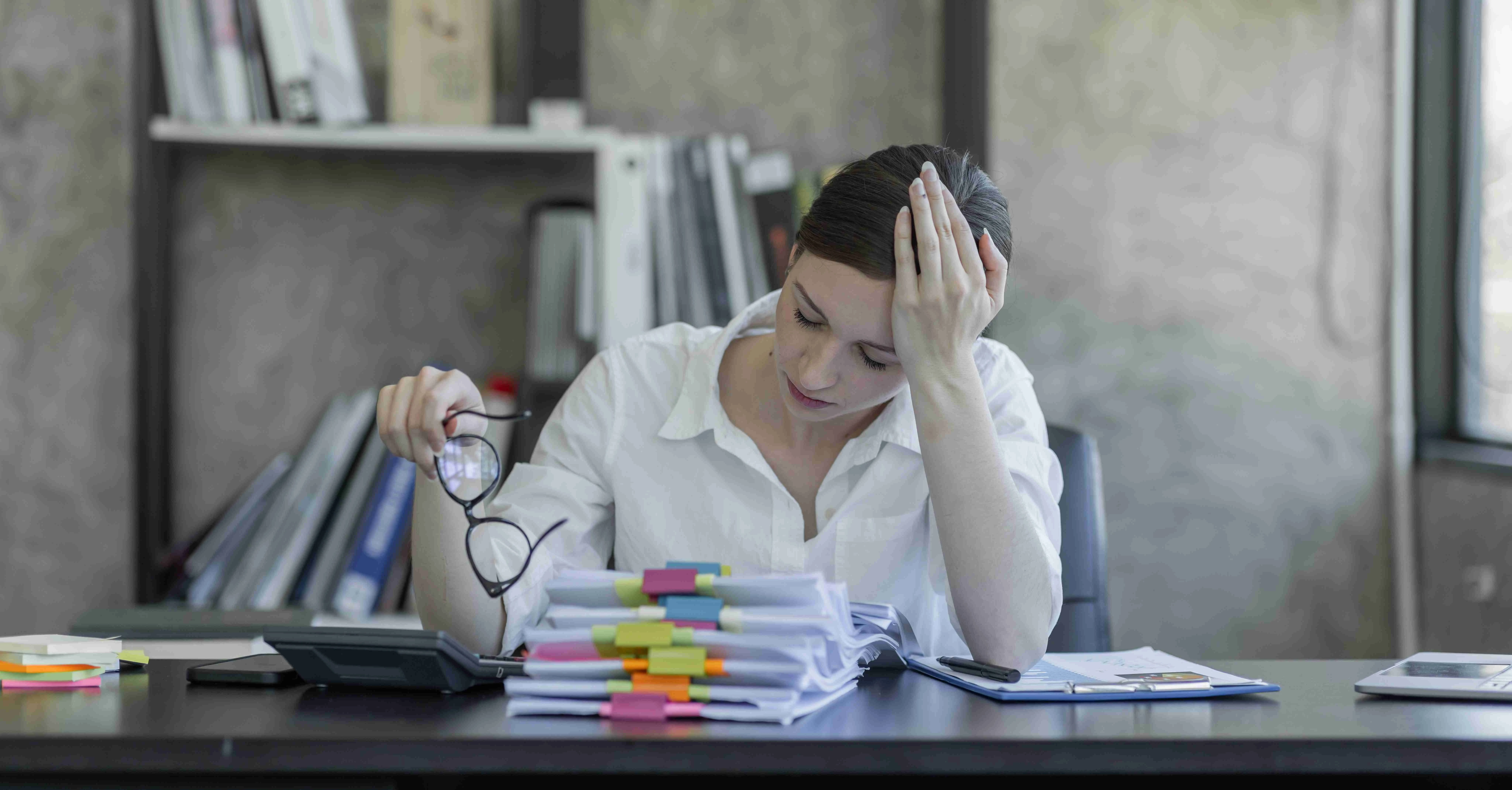 Stressed business Canadian woman working from home on laptop looking worried, tired and overwhelmed.