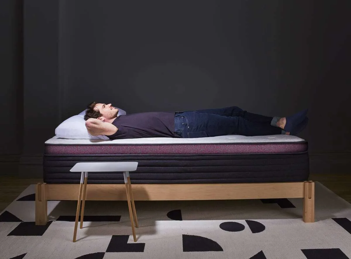 Reviewer lying on the Helix Dusk Luxe mattress
