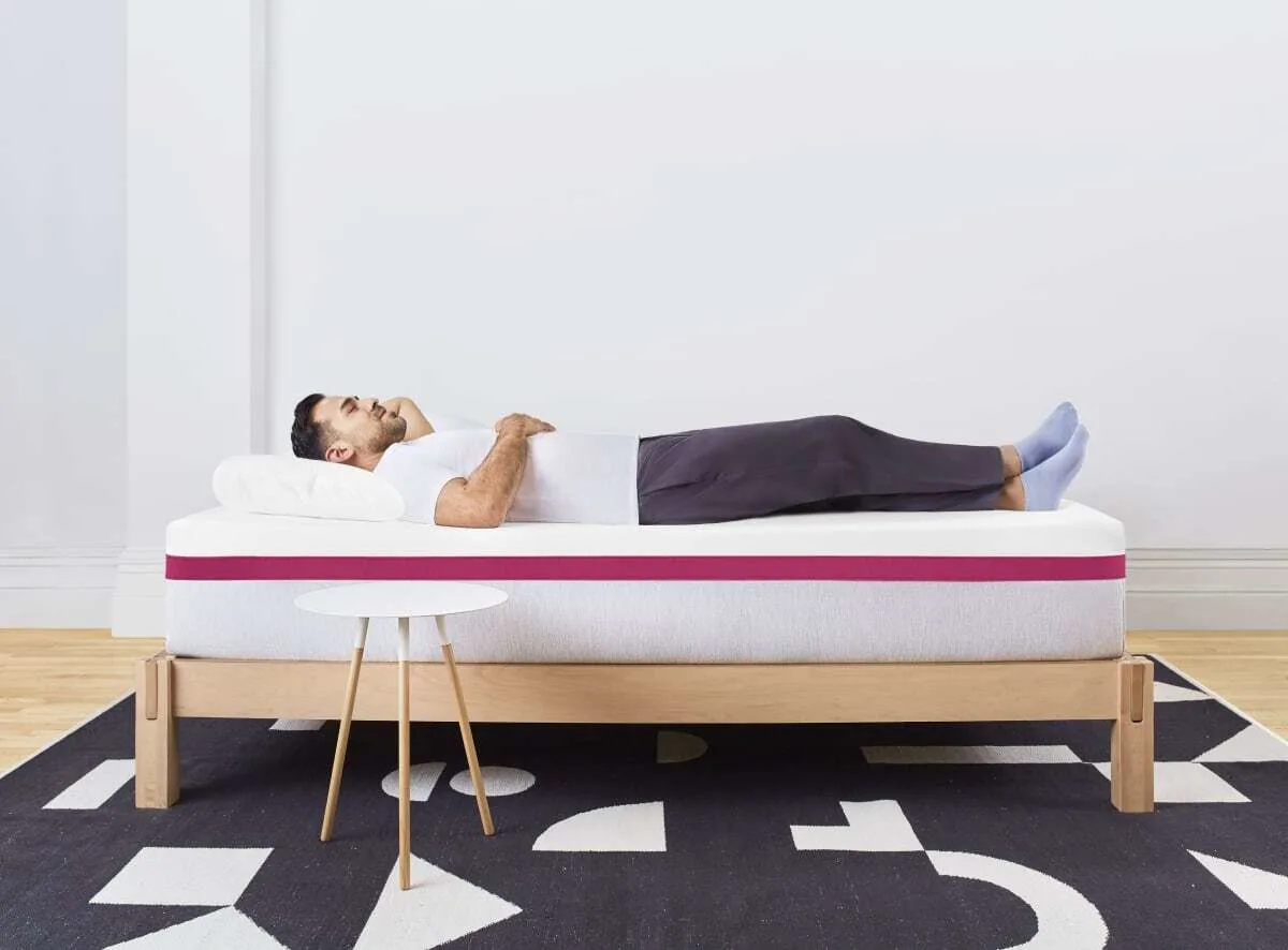 reviewer lying on Helix Dusk mattress