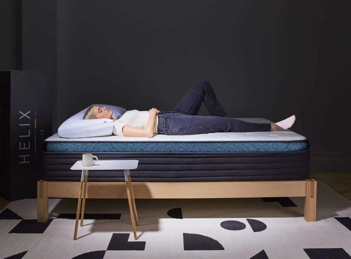 a reviewer laying on Helix Moonlight Luxe mattress