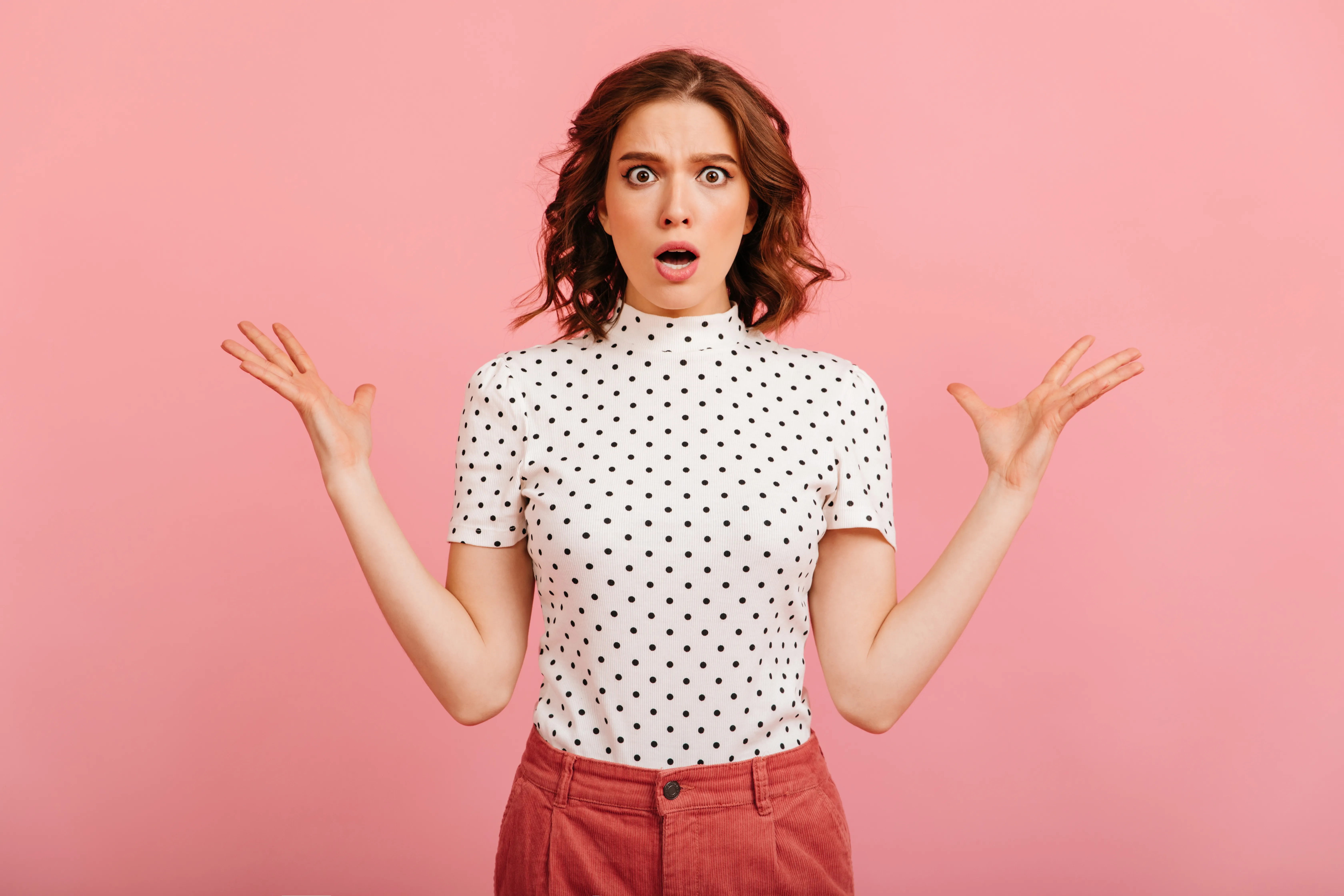 Disappointed girl in t-shirt waving hands