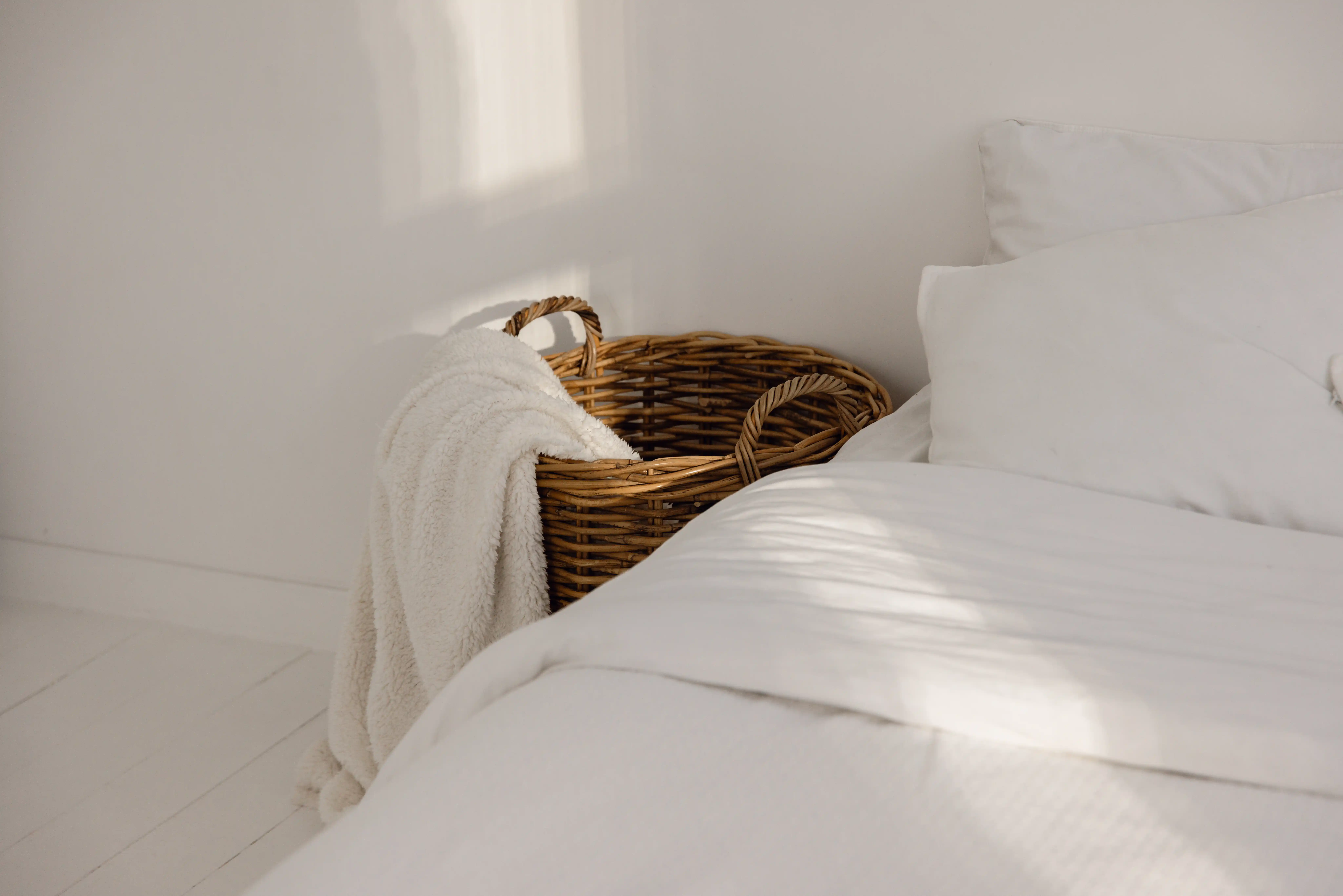 Neatly made bed with clean white sheets