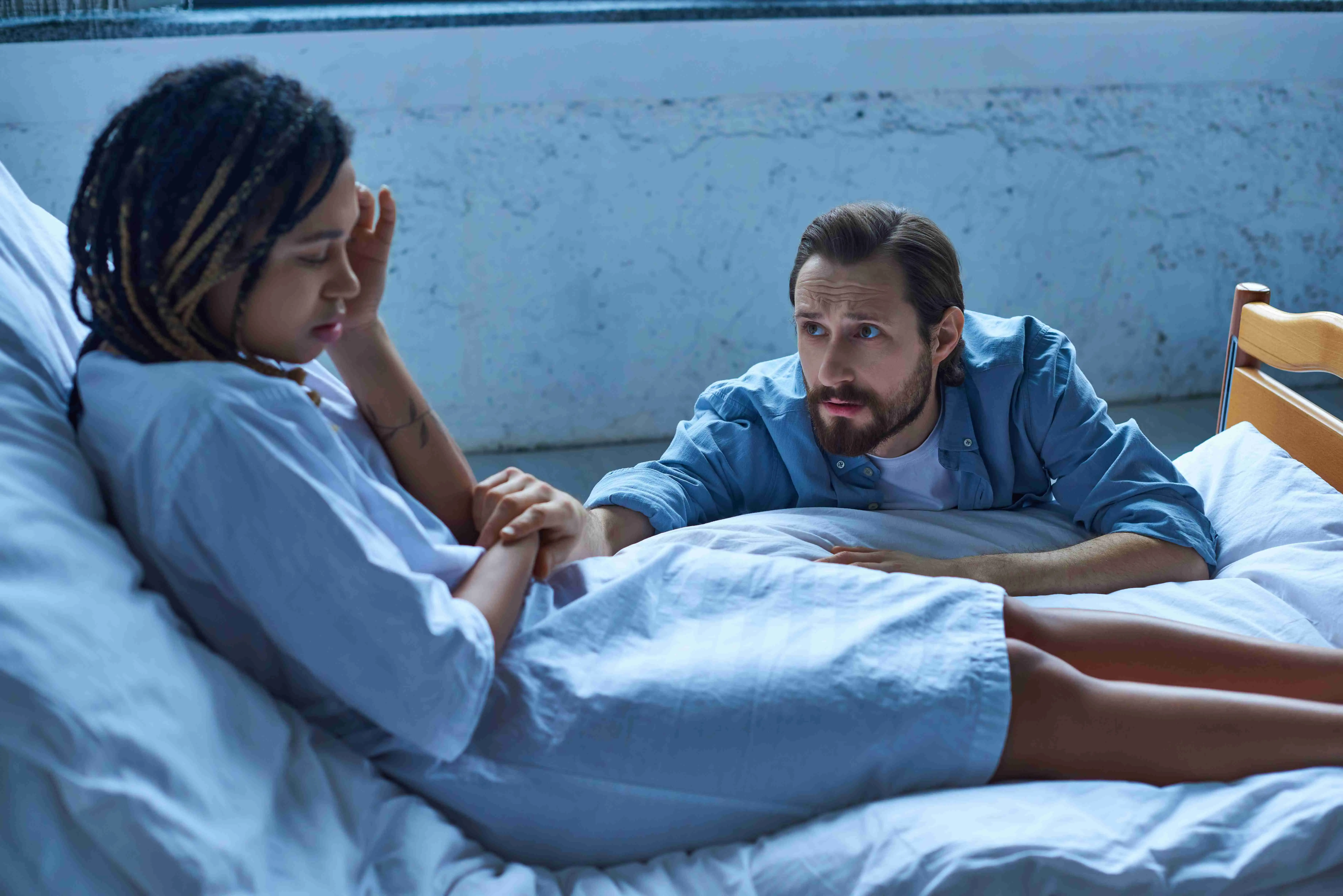 sad man calming down depressed African American wife