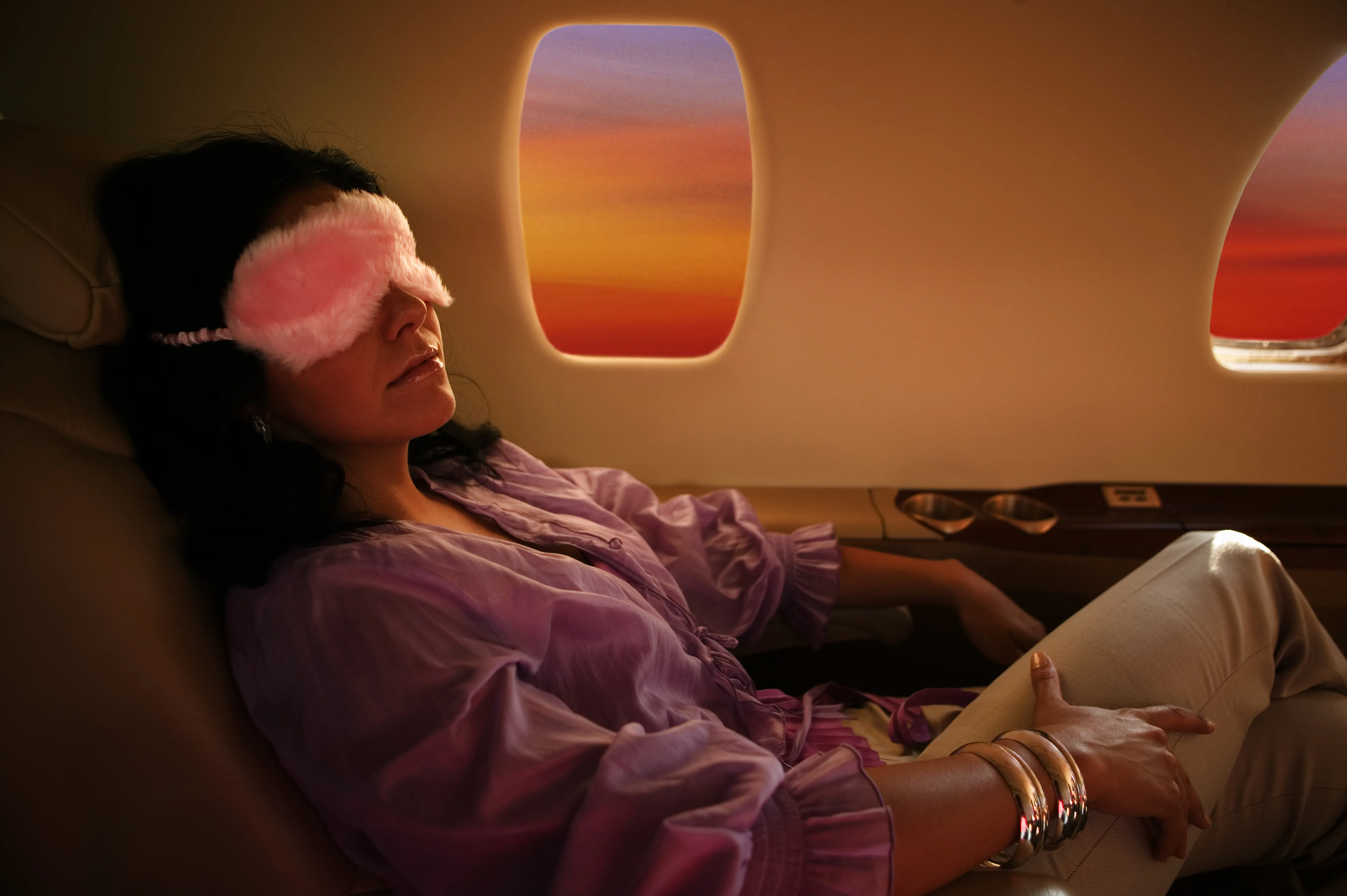 Woman Sleeping With Sleep Mask In Airplane