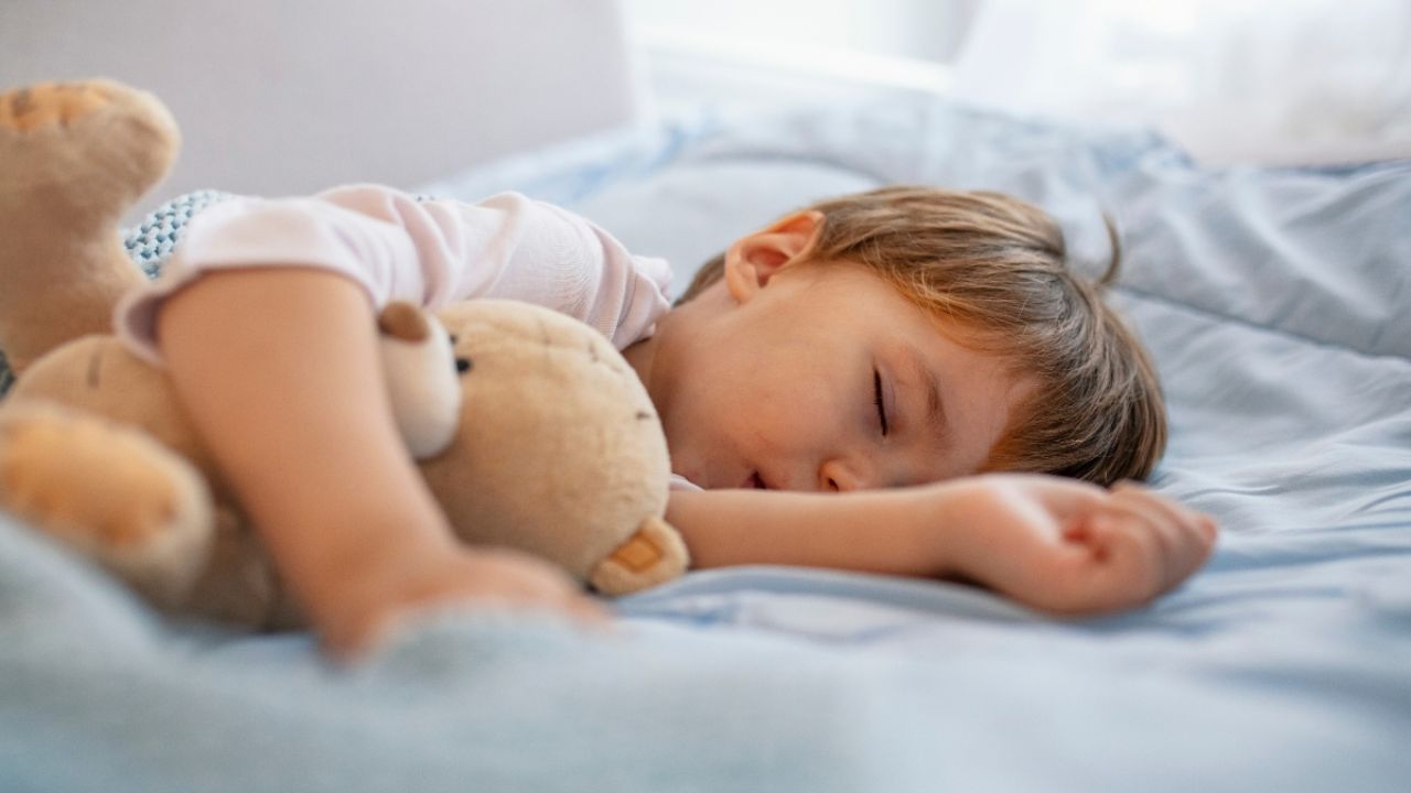 baby sleeping on mattress