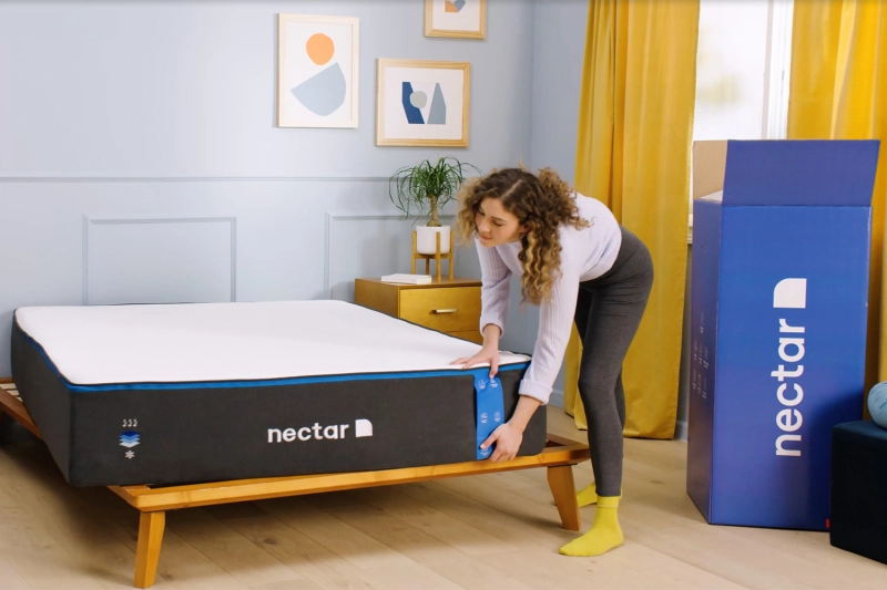 woman holding nectar memory foam mattress