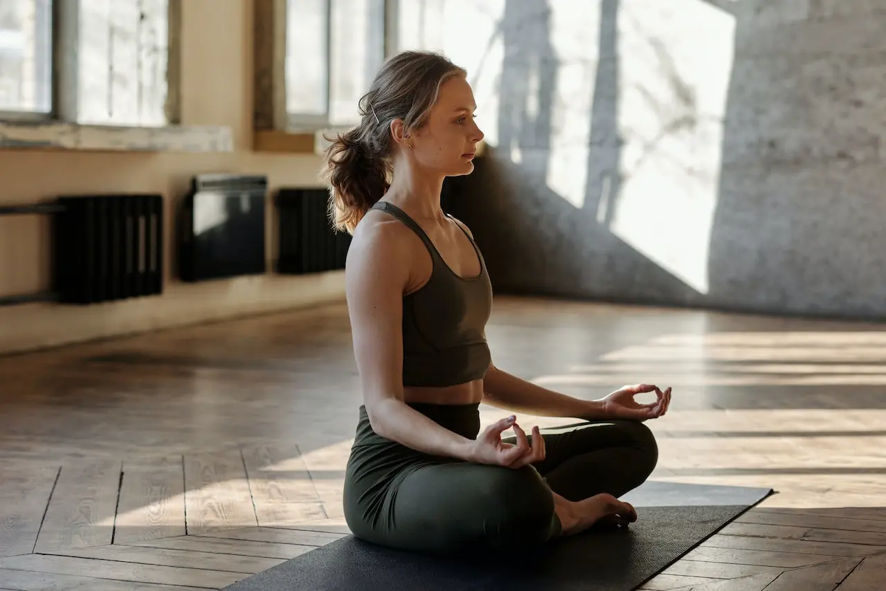 Woman sitting on a yoga mat