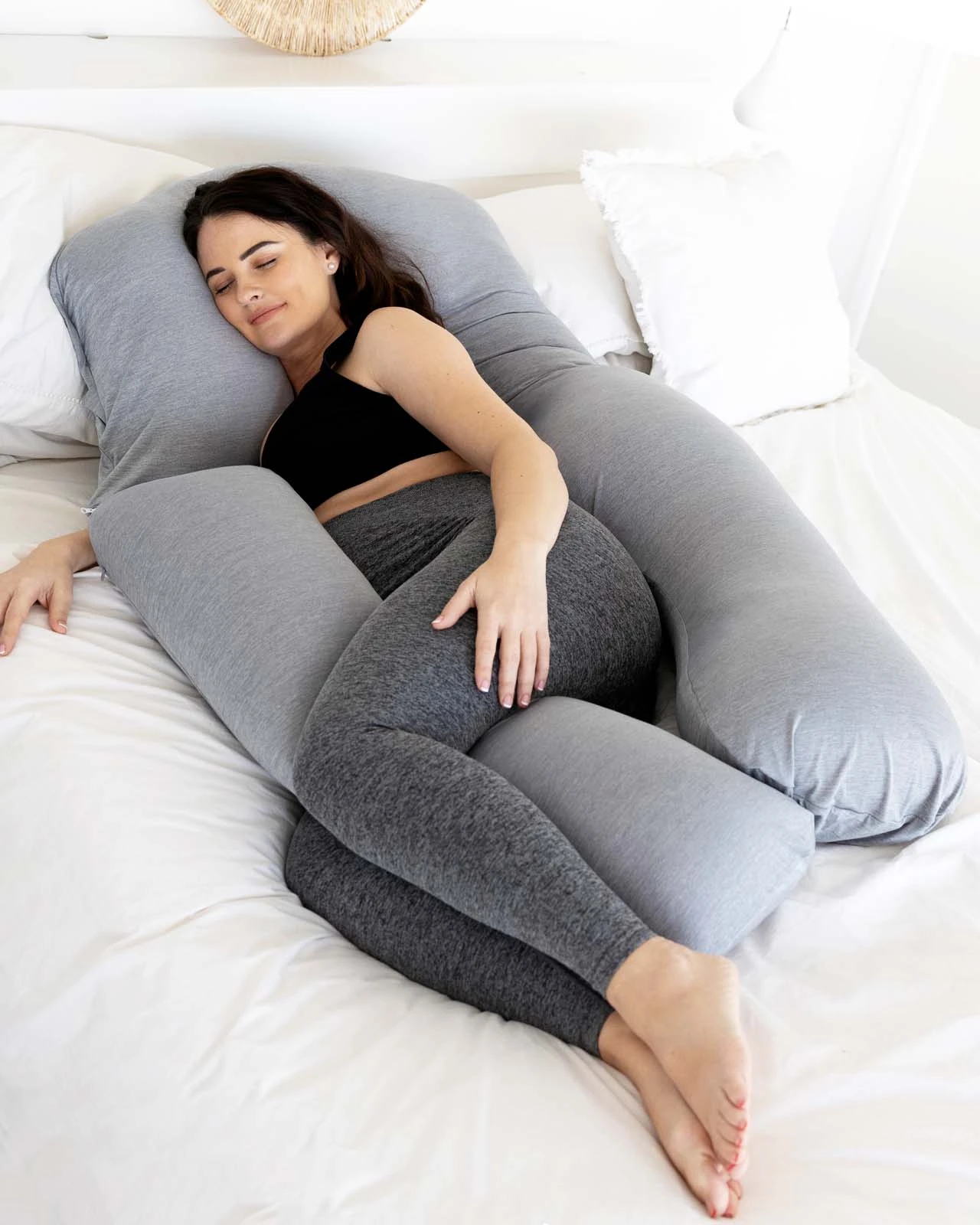 women sleeping in a body pillow