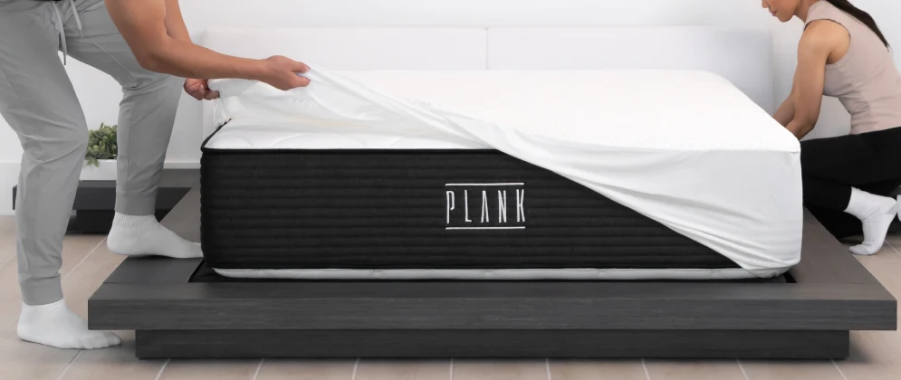 Reviewers puttinf a bedding on Plank Firm Luxe mattress