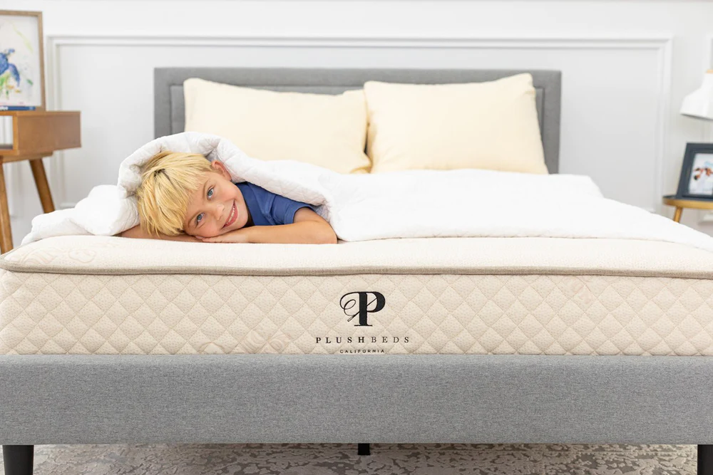 A child sleeping on the PlushBeds Healthy Child Hybrid mattress