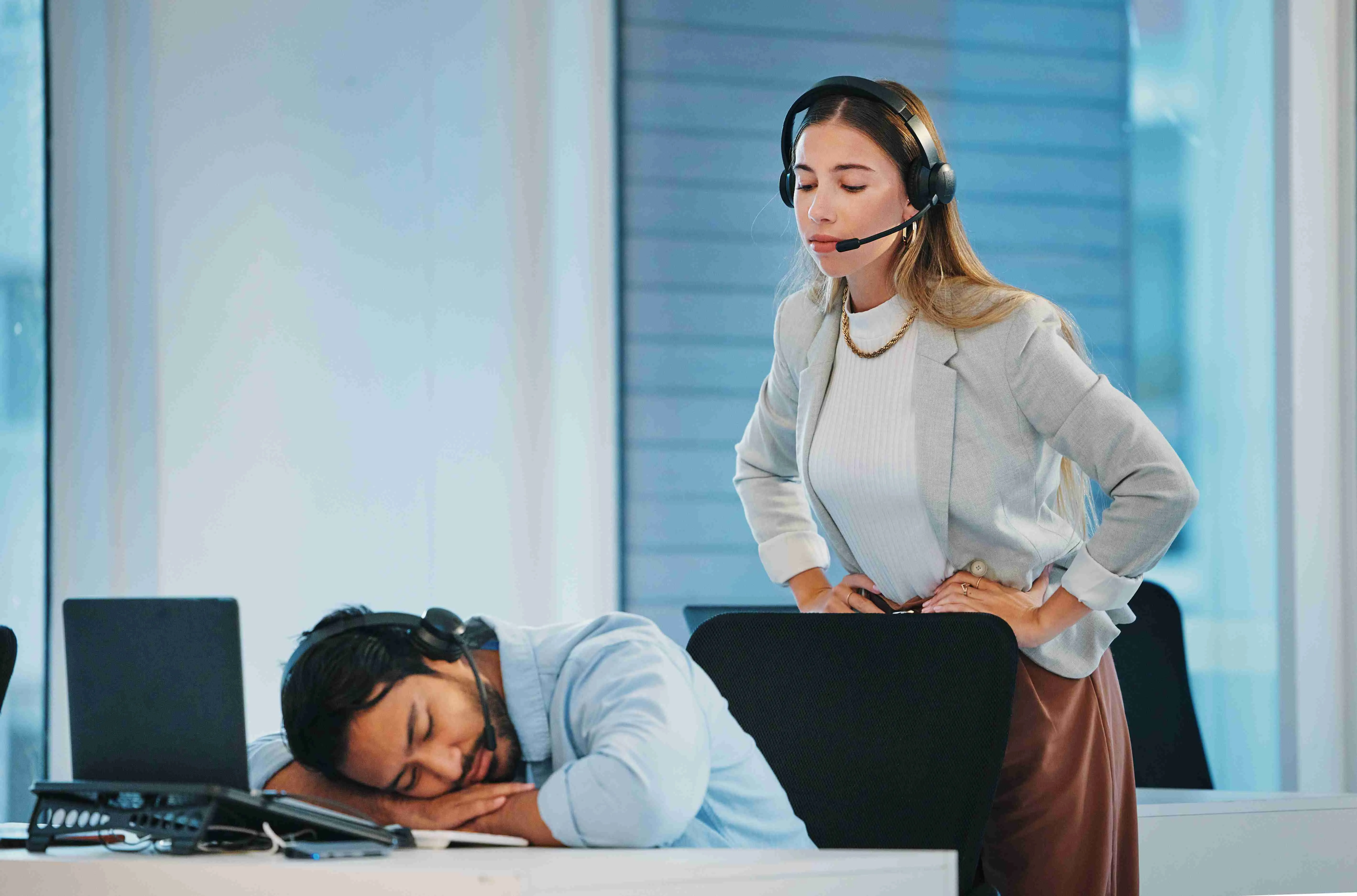 Boss, lazy and man employee in office at laptop telemarketing center