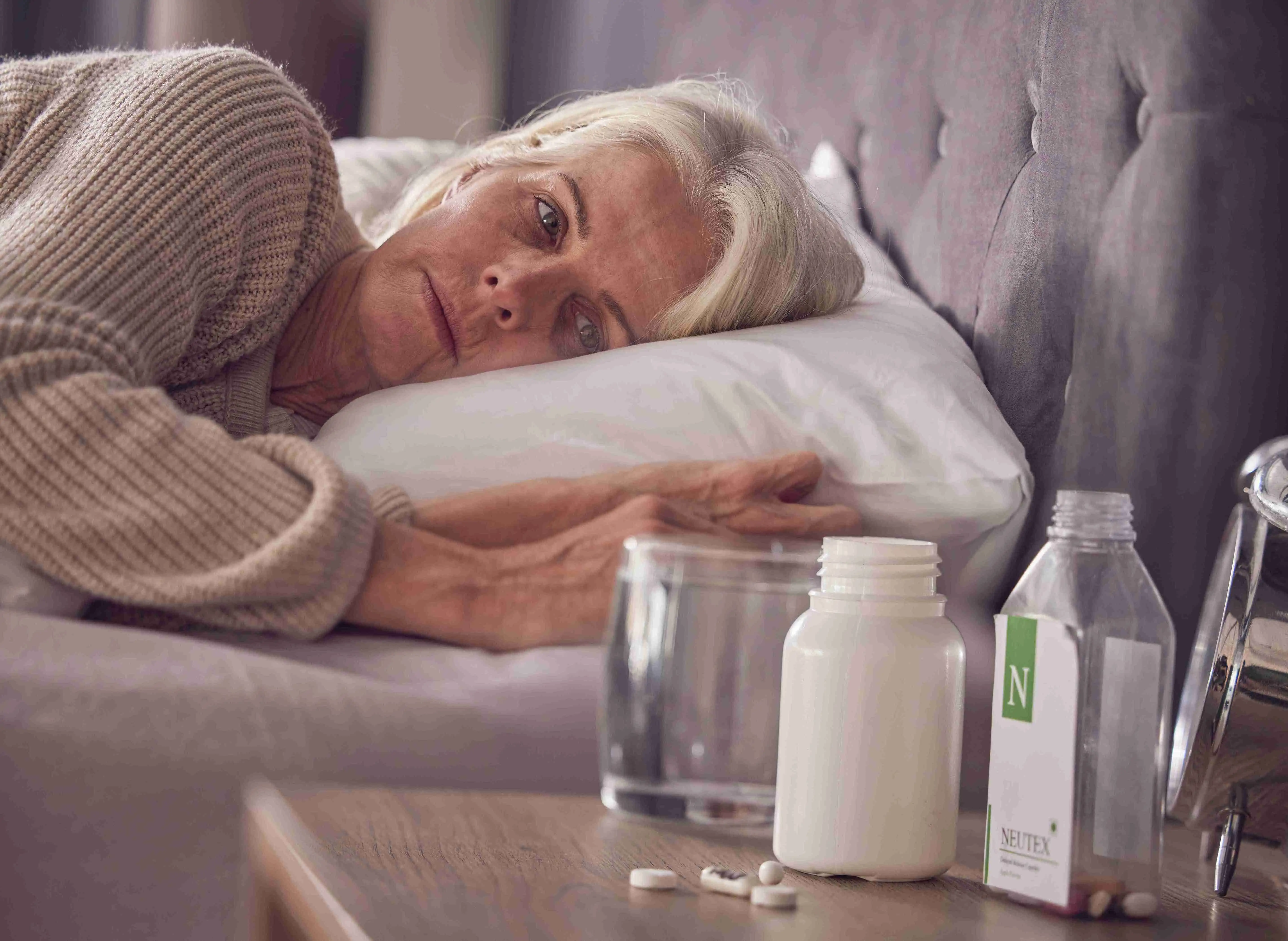 Elderly woman, bed and medical addiction with pills