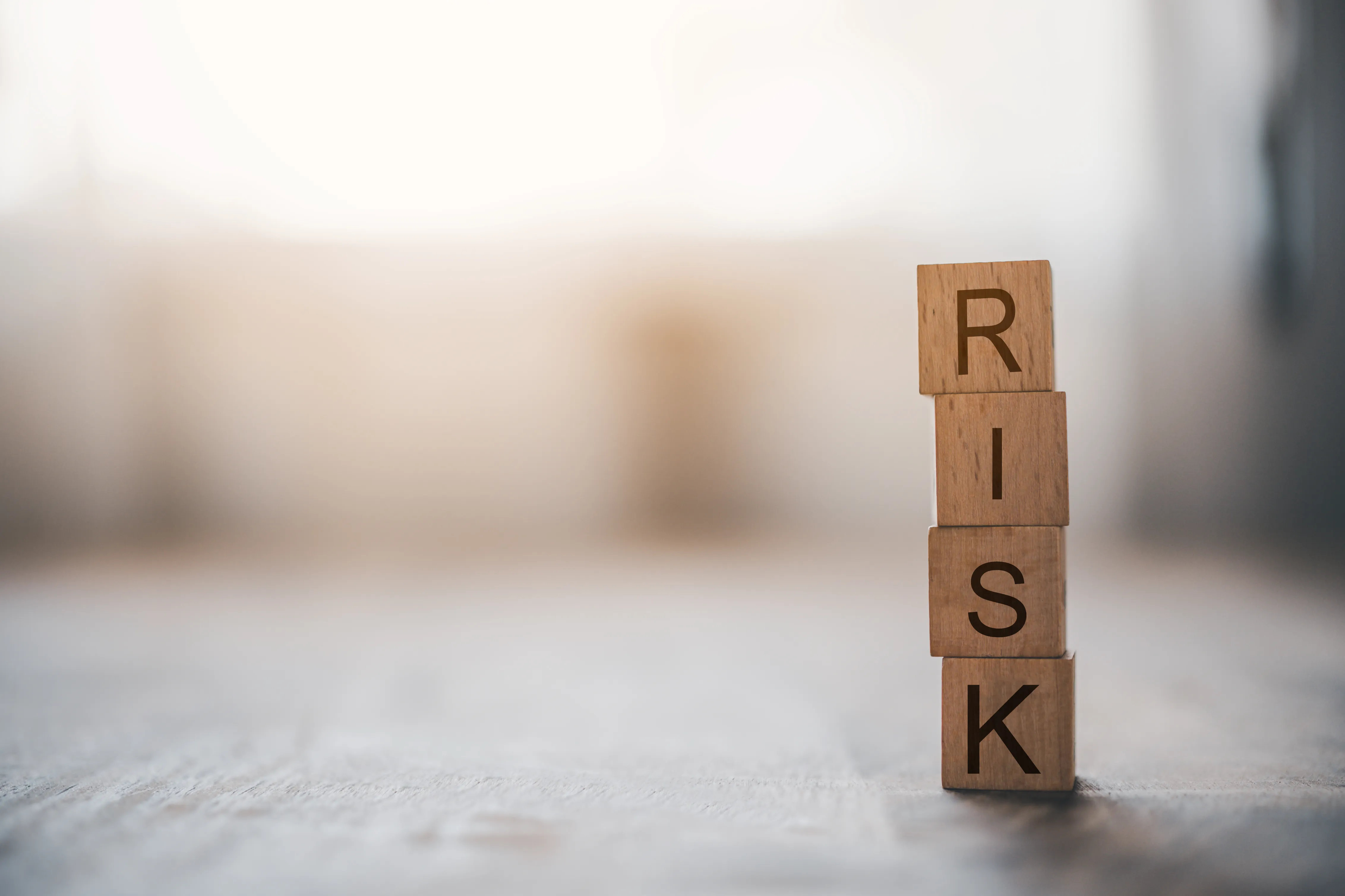 wooden block with the word "RISK"
