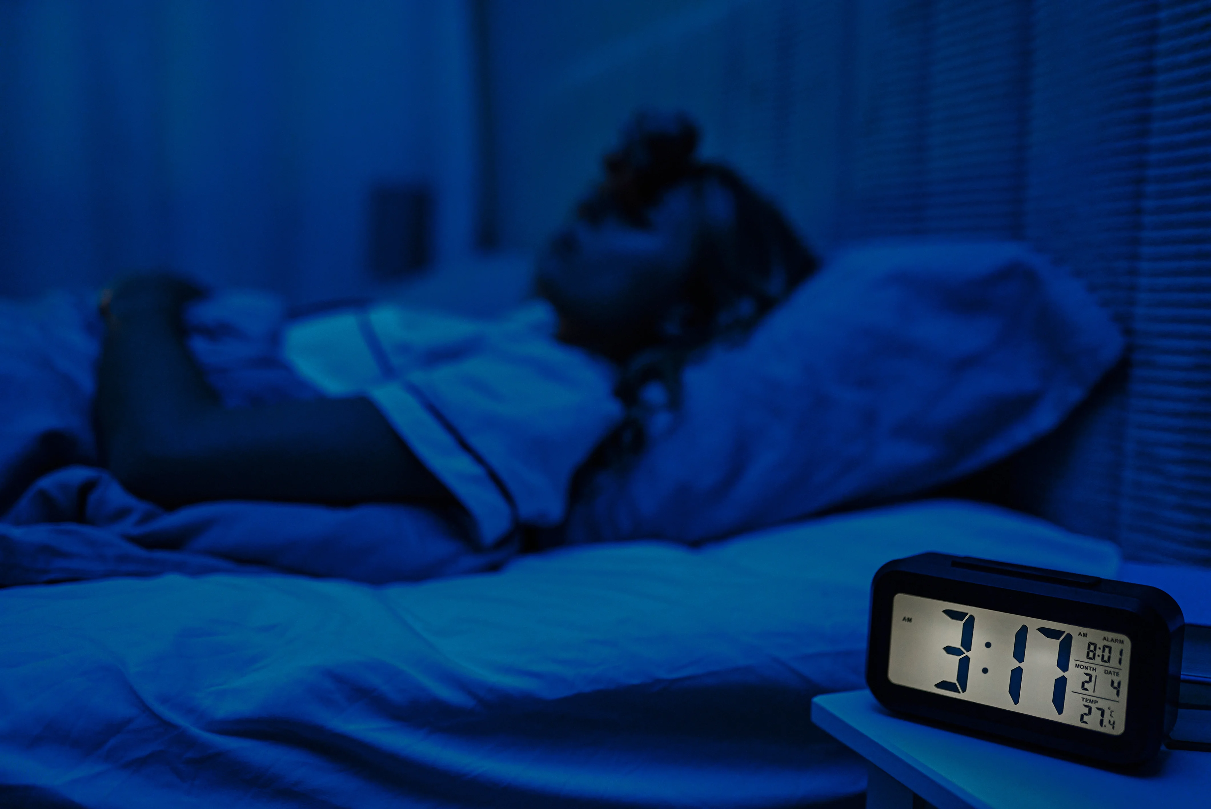 Person awake in bed at night