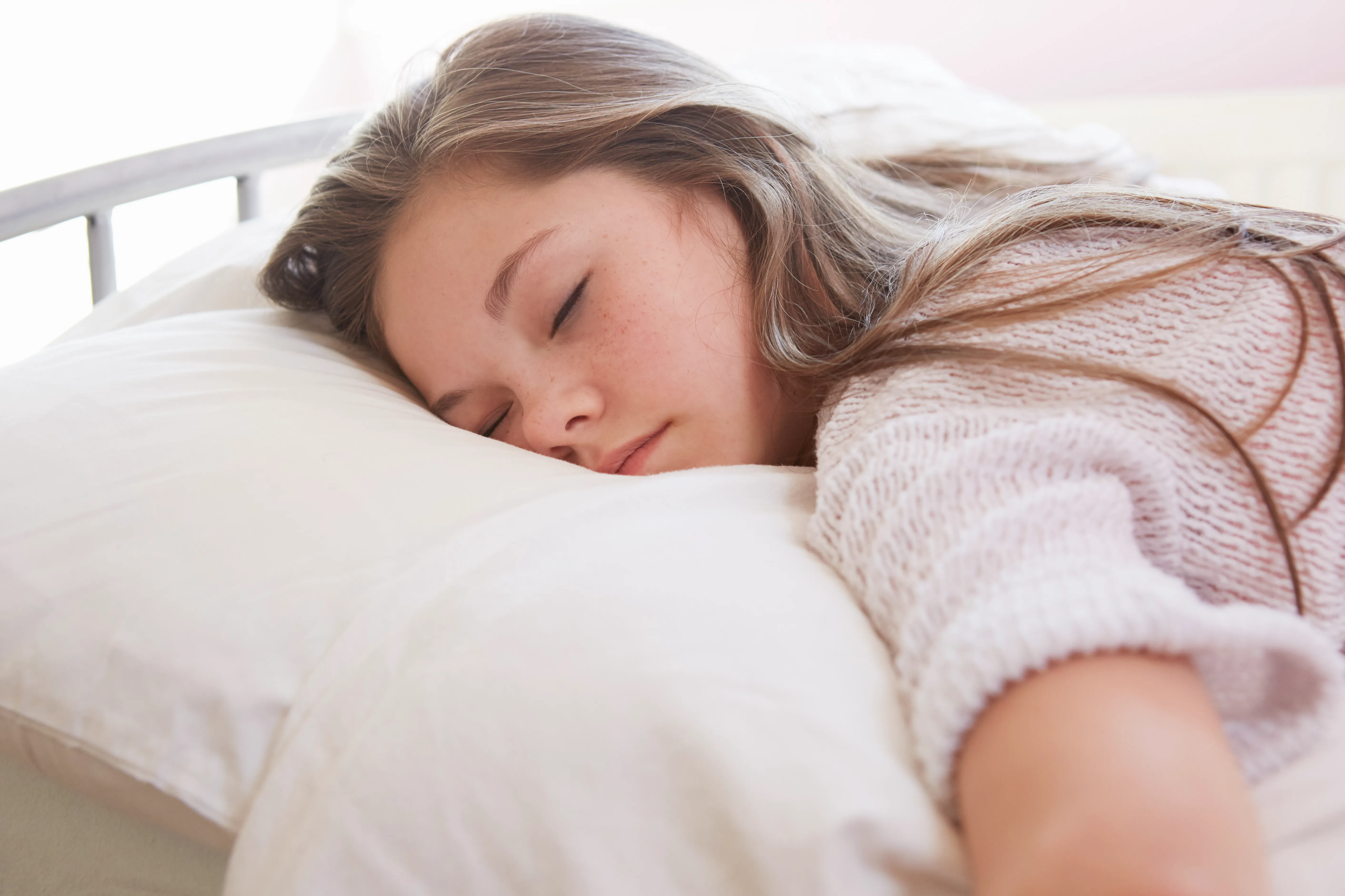 Girl lying on bed asleep