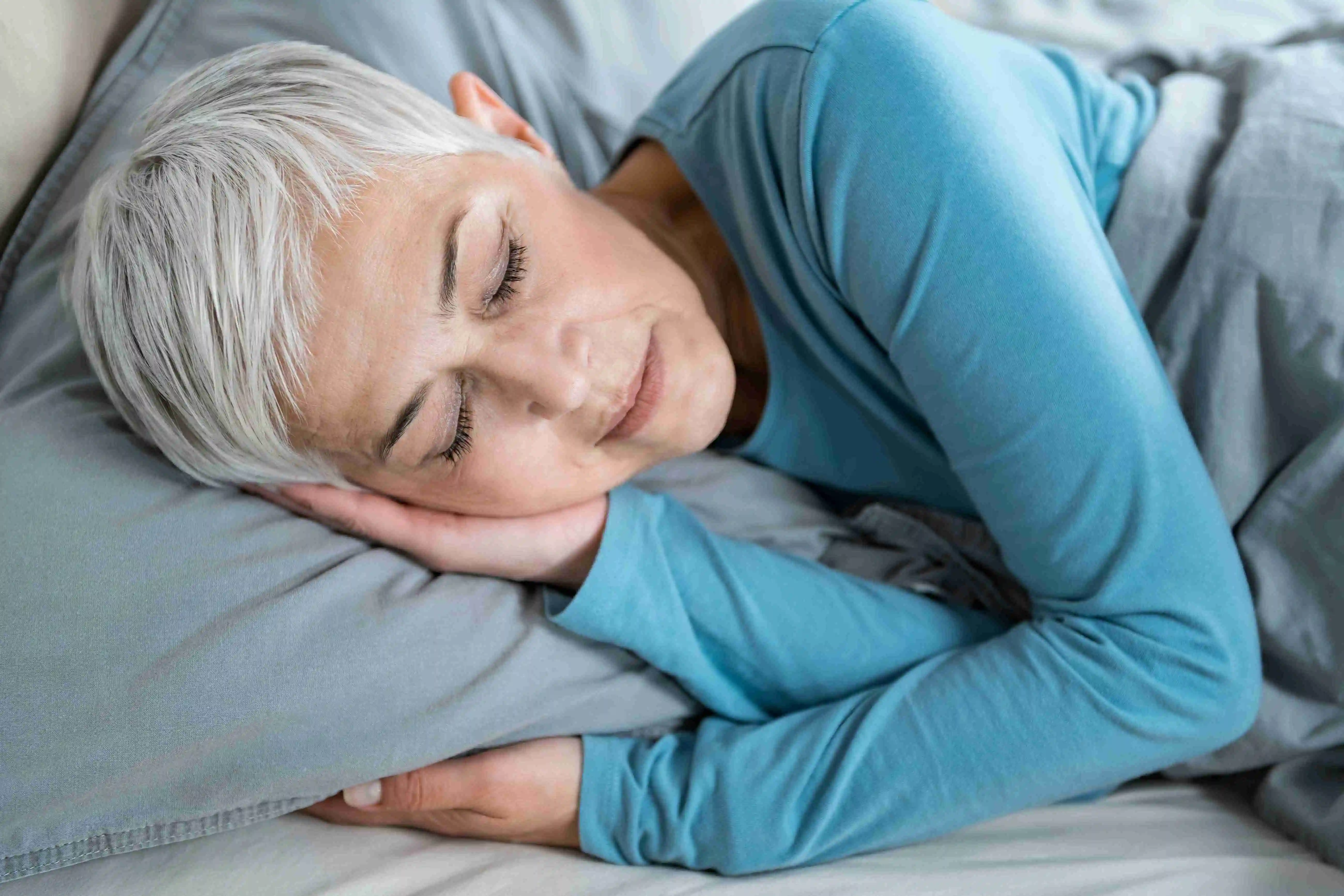 Woman Sleeping in Bed