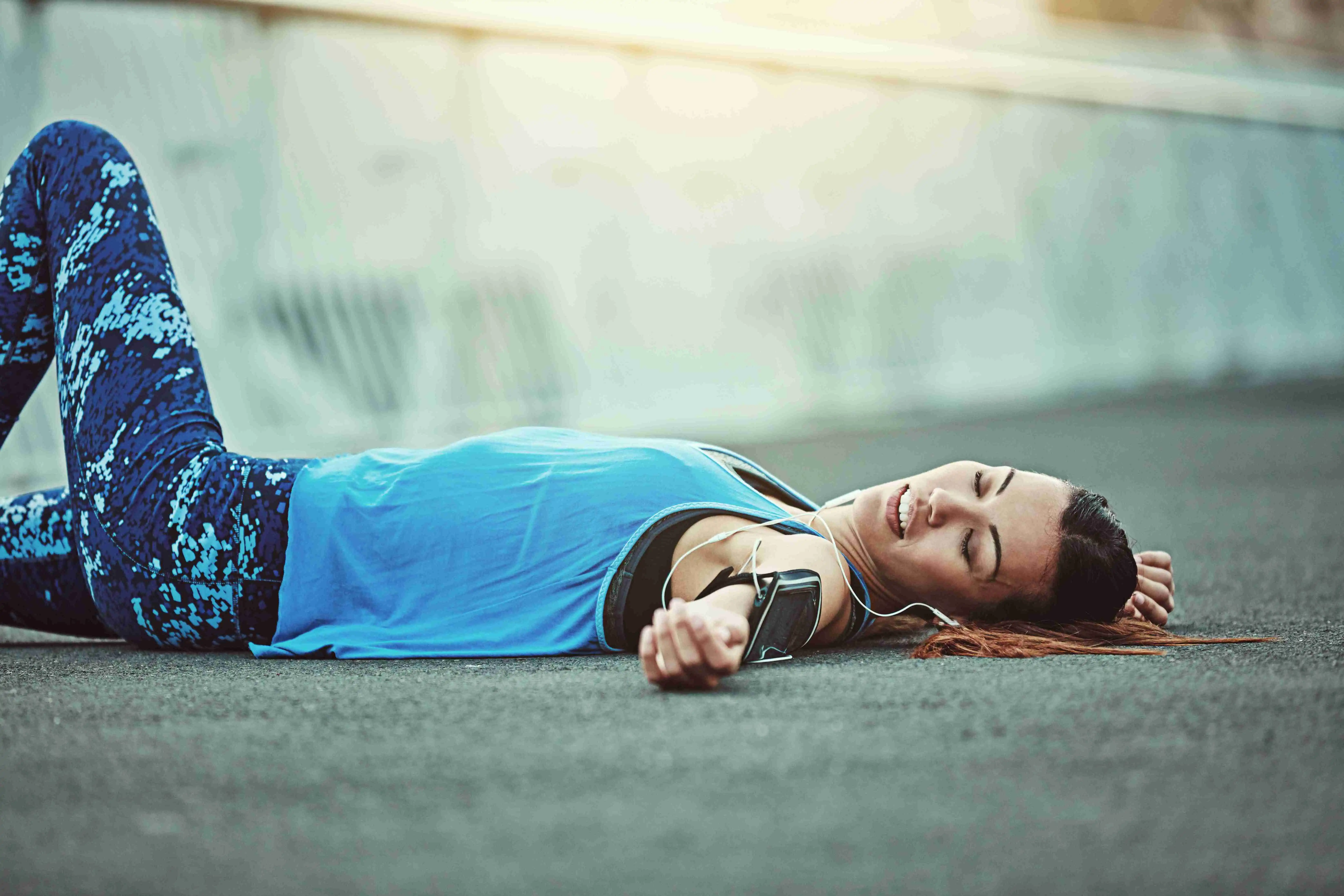 Shot of a young woman looking exhausted during her morning run.