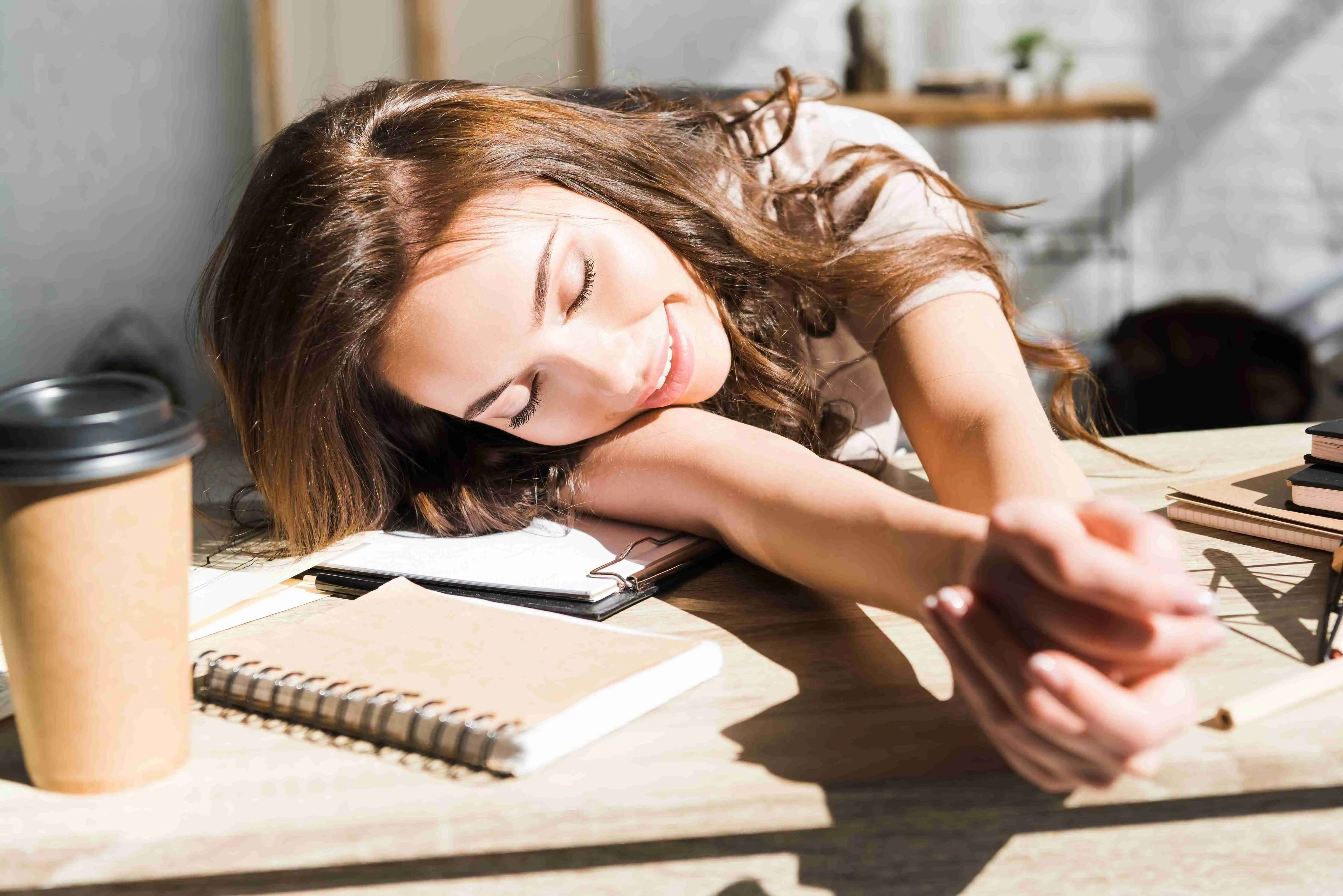 selective focus of cheerful and beautiful young woman with closed eyes and clenched hands