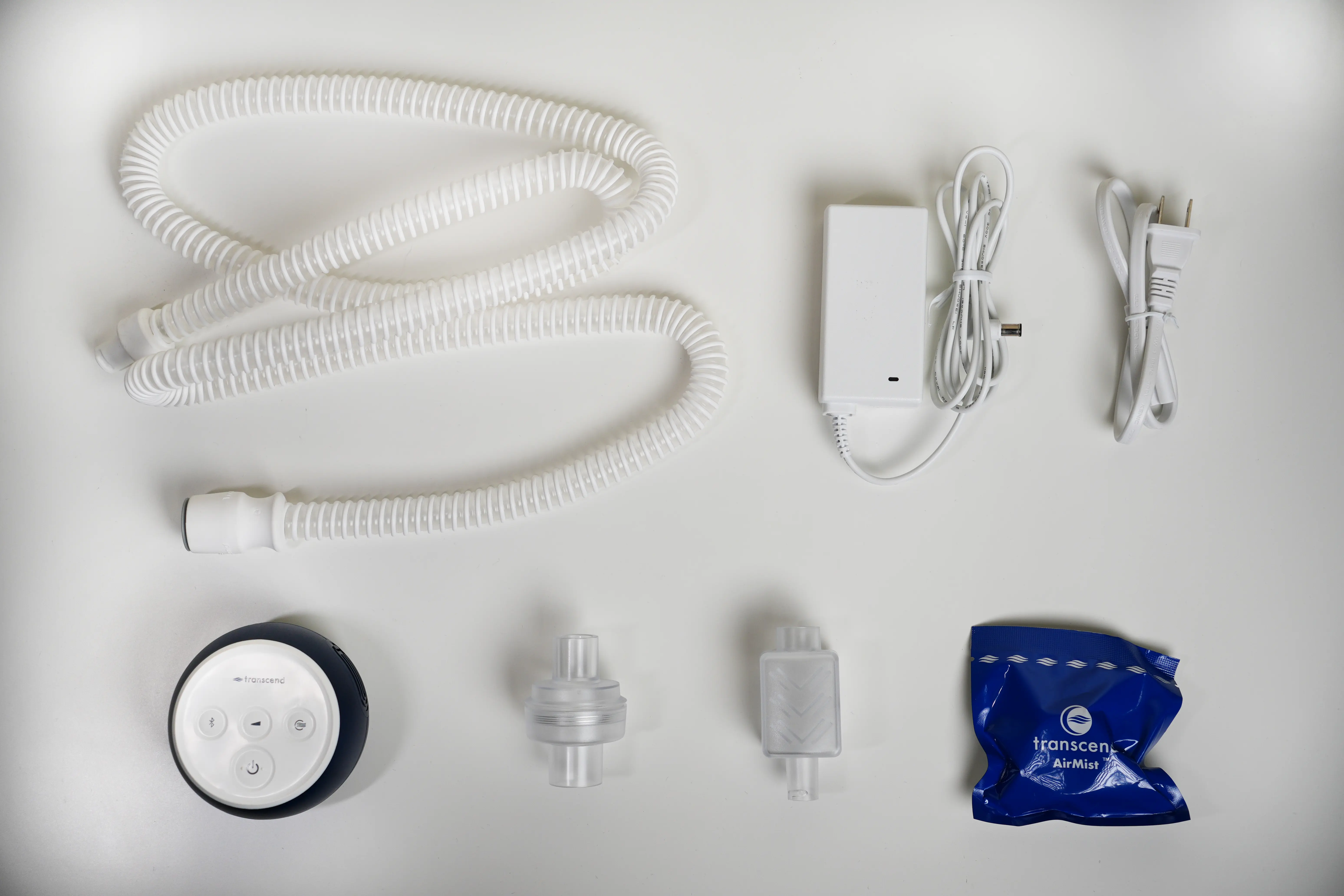 The Micro 510, hose, power supply, connectors, muffler, and AirMist packaging laid out on a neutral background.