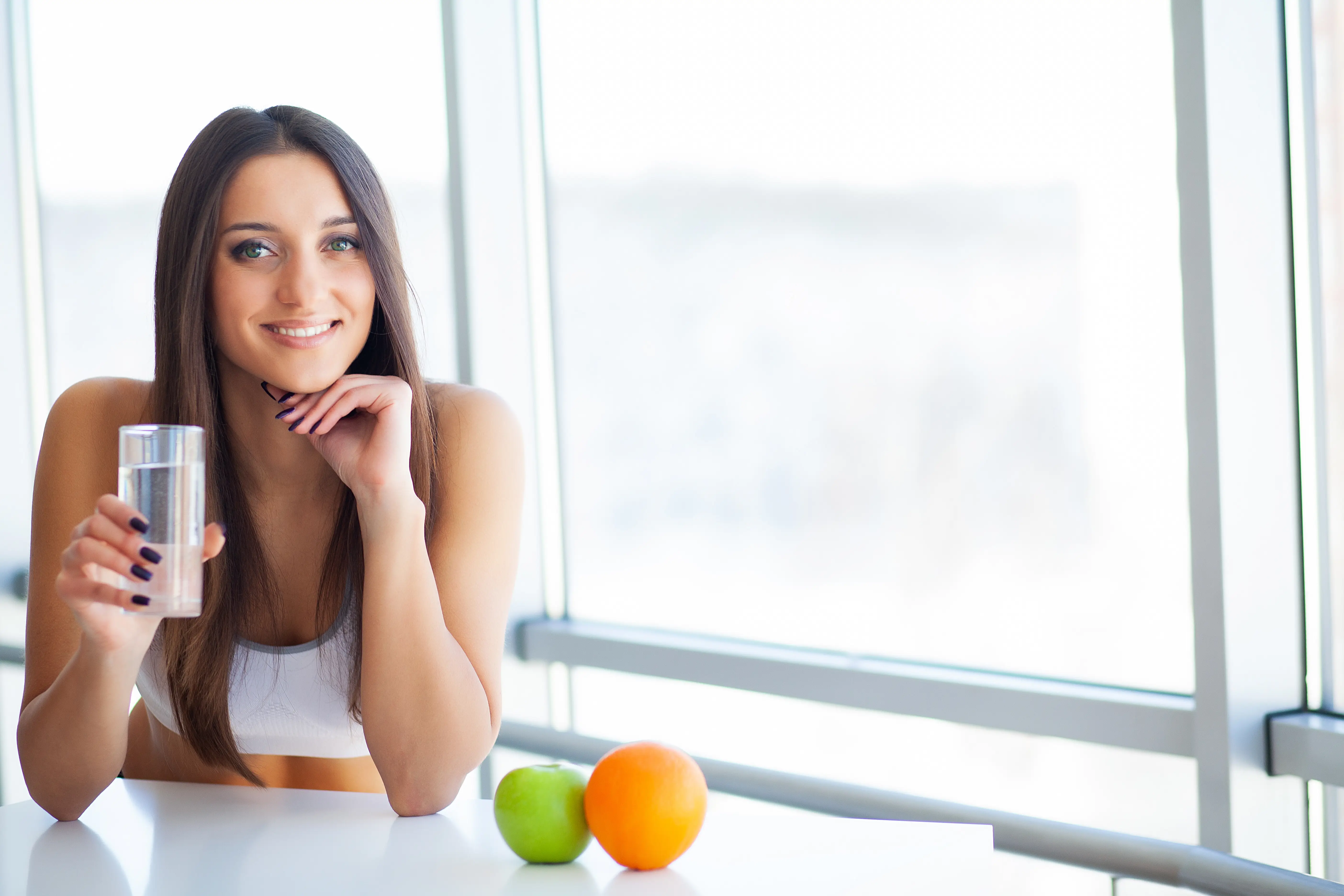 Beautiful Smiling Woman Taking Vitamin Pill. Dietary Supplement