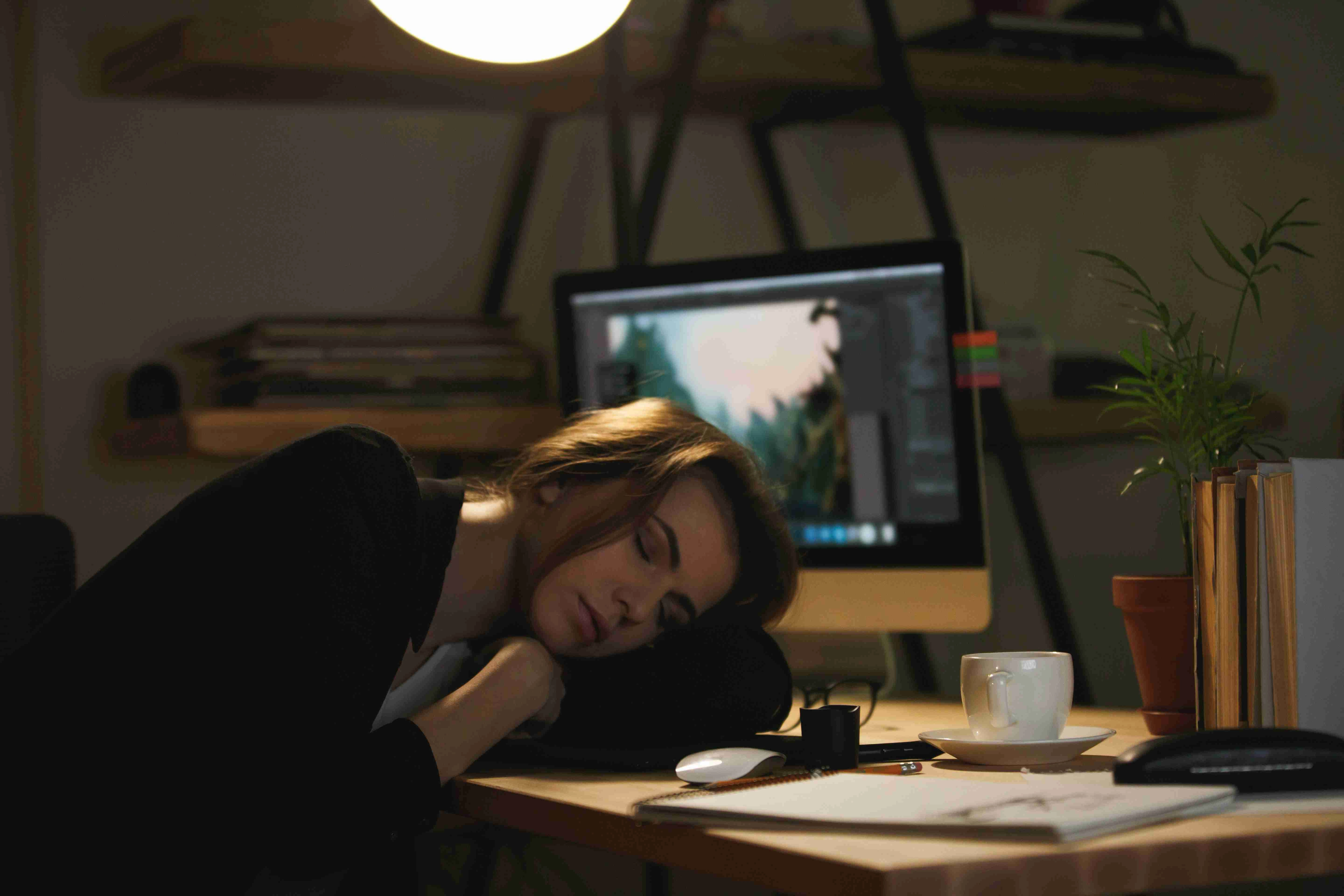 Lady designer sleeping on workspace