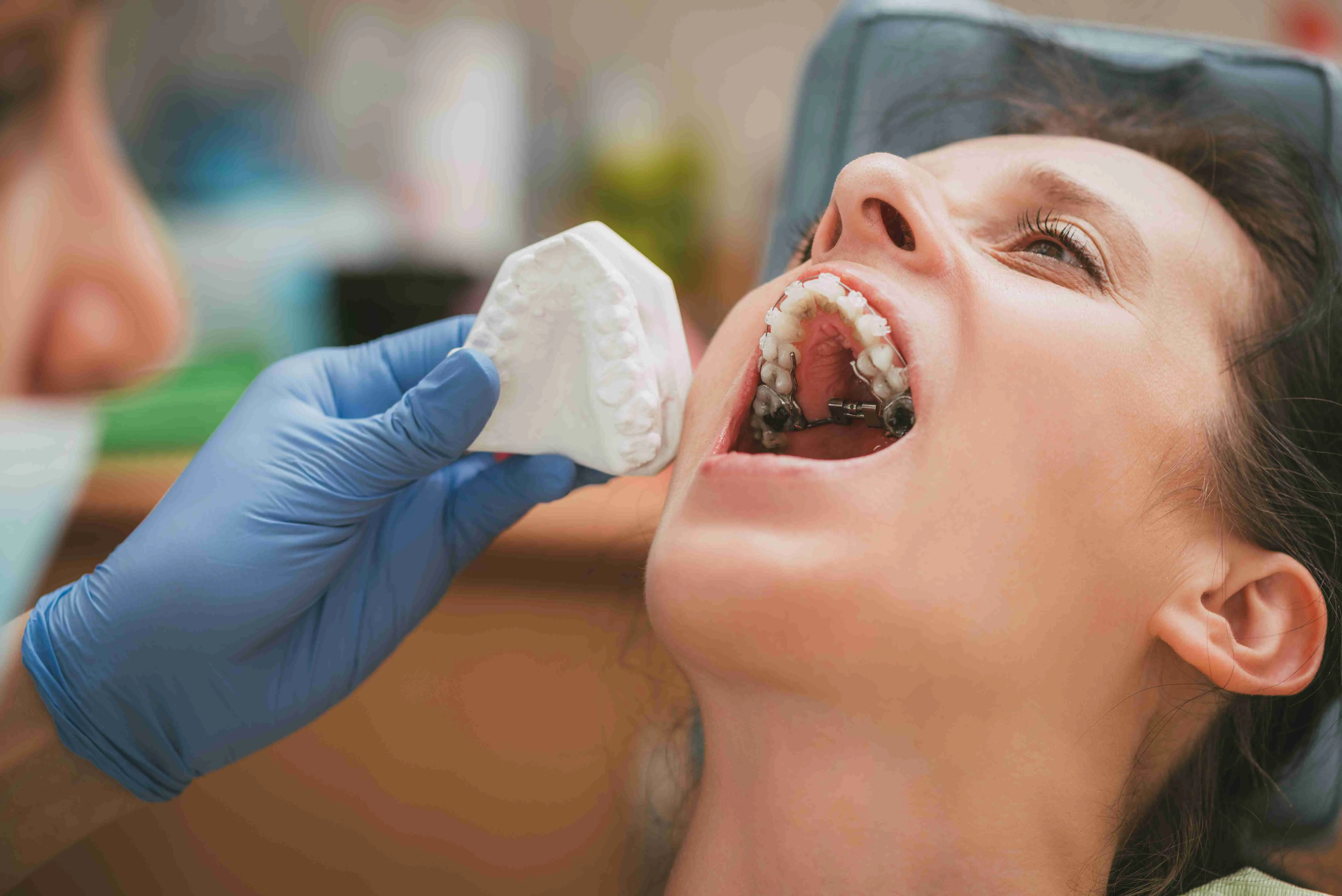 Dentist checking braces on the female patient