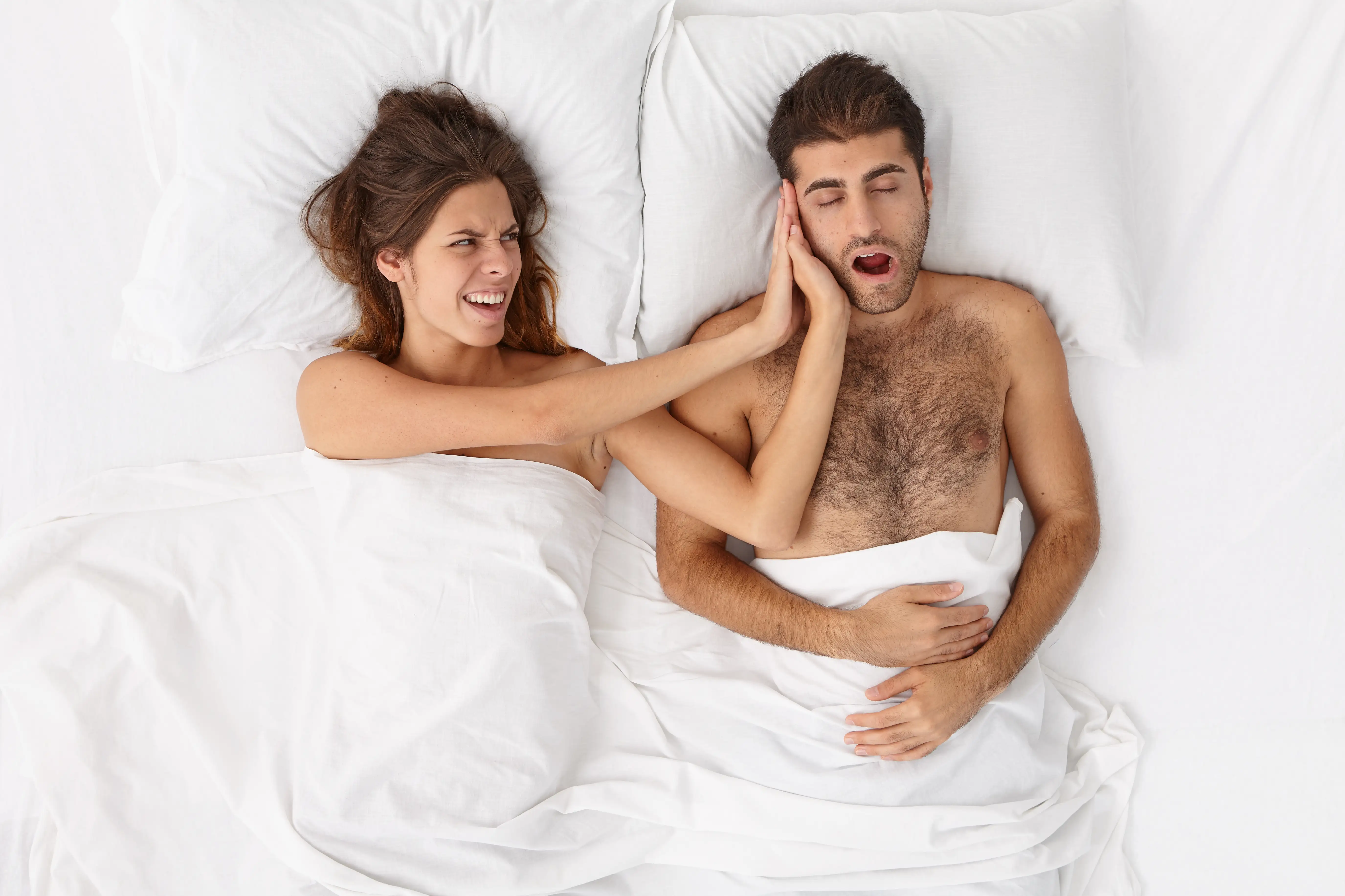 Frustrated annoyed woman cant stand mans snoring in bed during night, feels disturbed