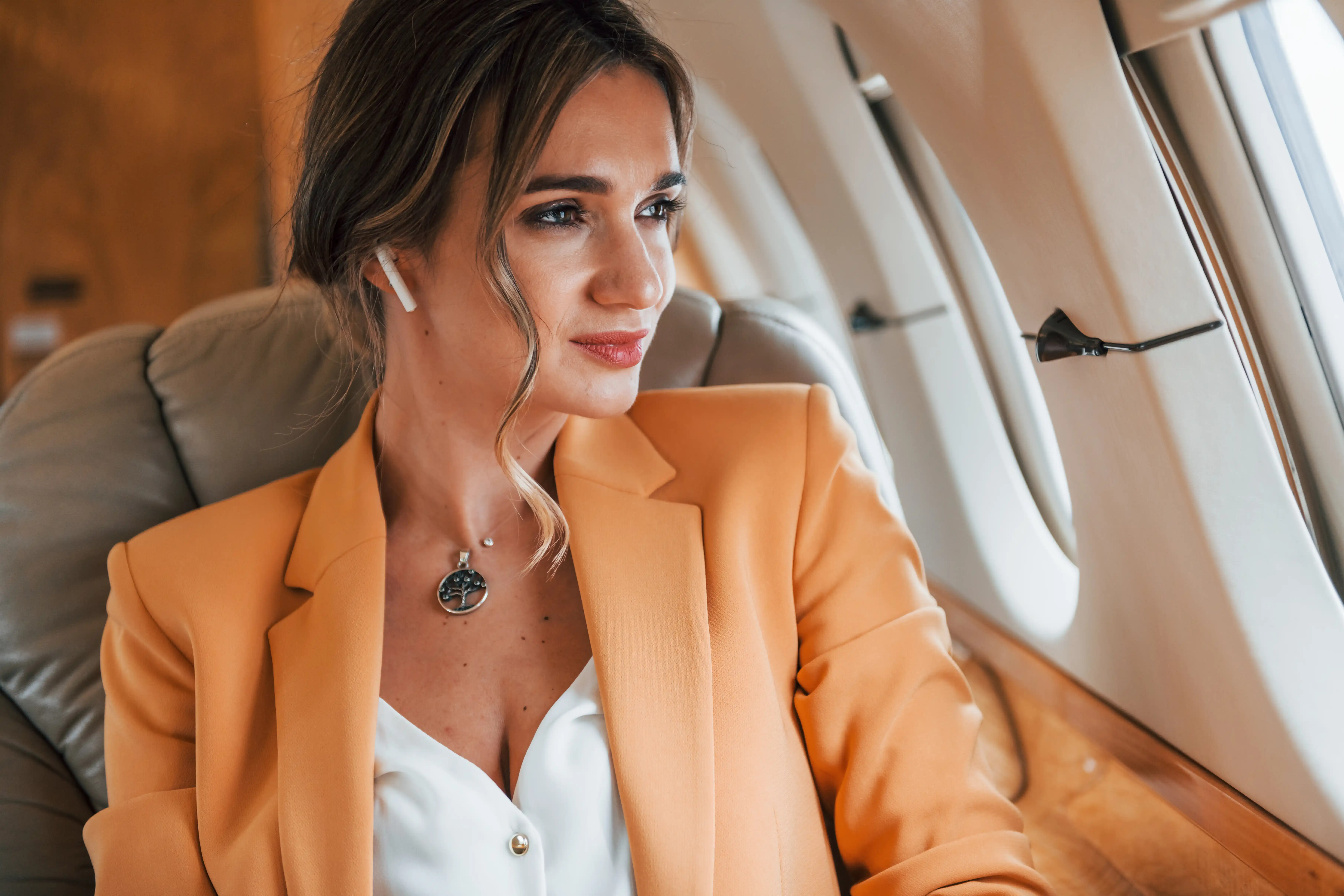 Young passenger woman in yellow clothes is flying in the plane