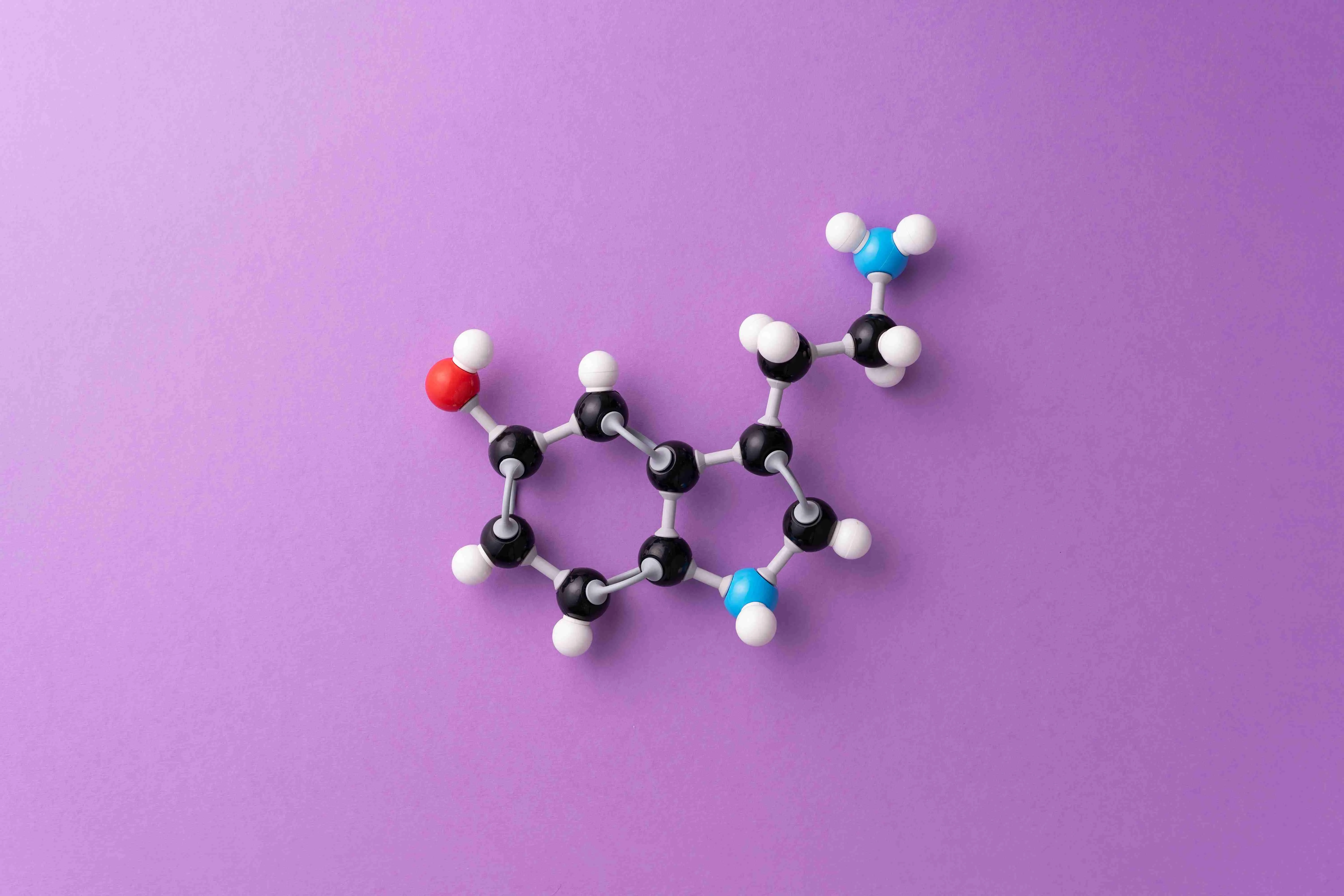 Serotonin chemical formula over purple background