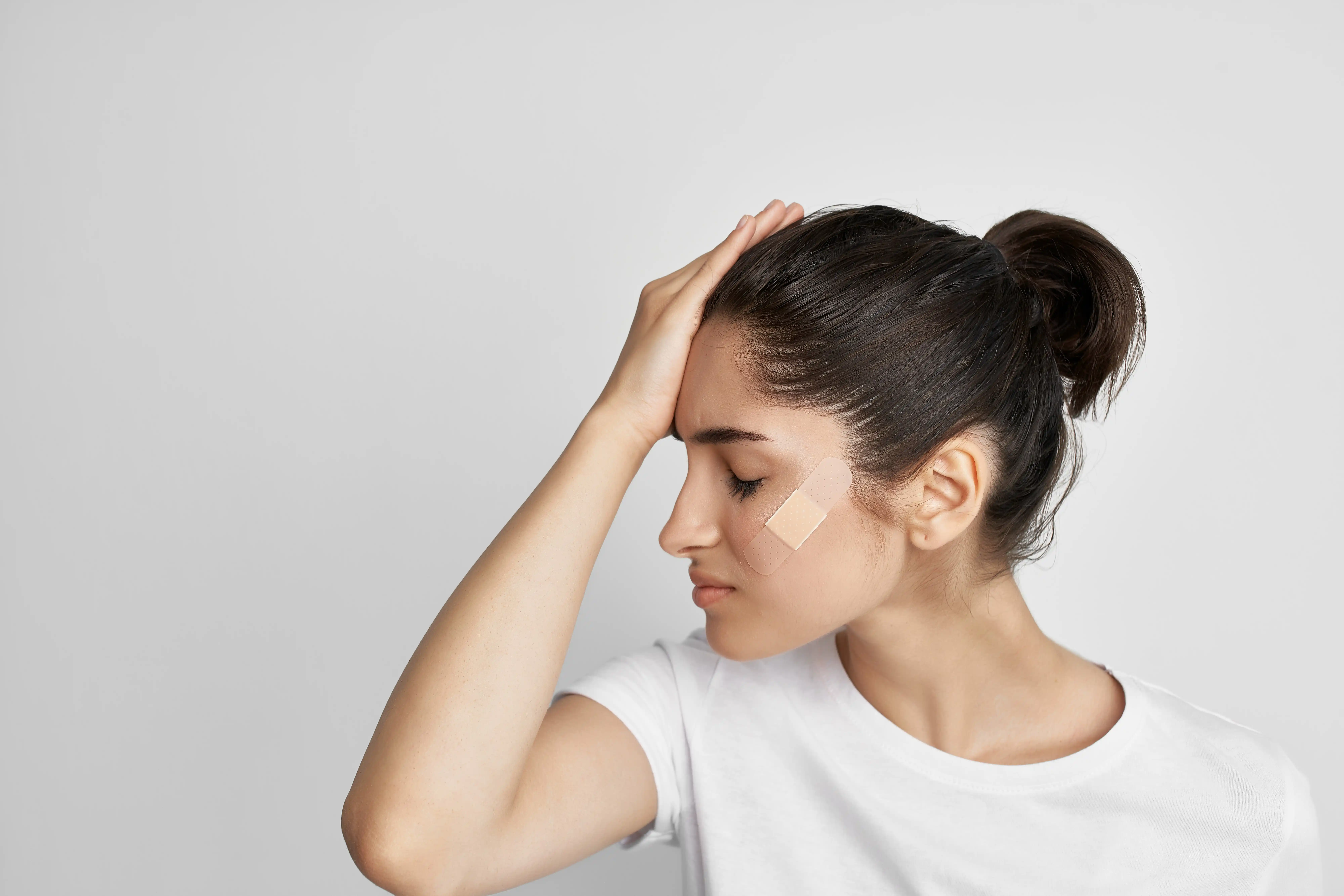 woman holding her head
