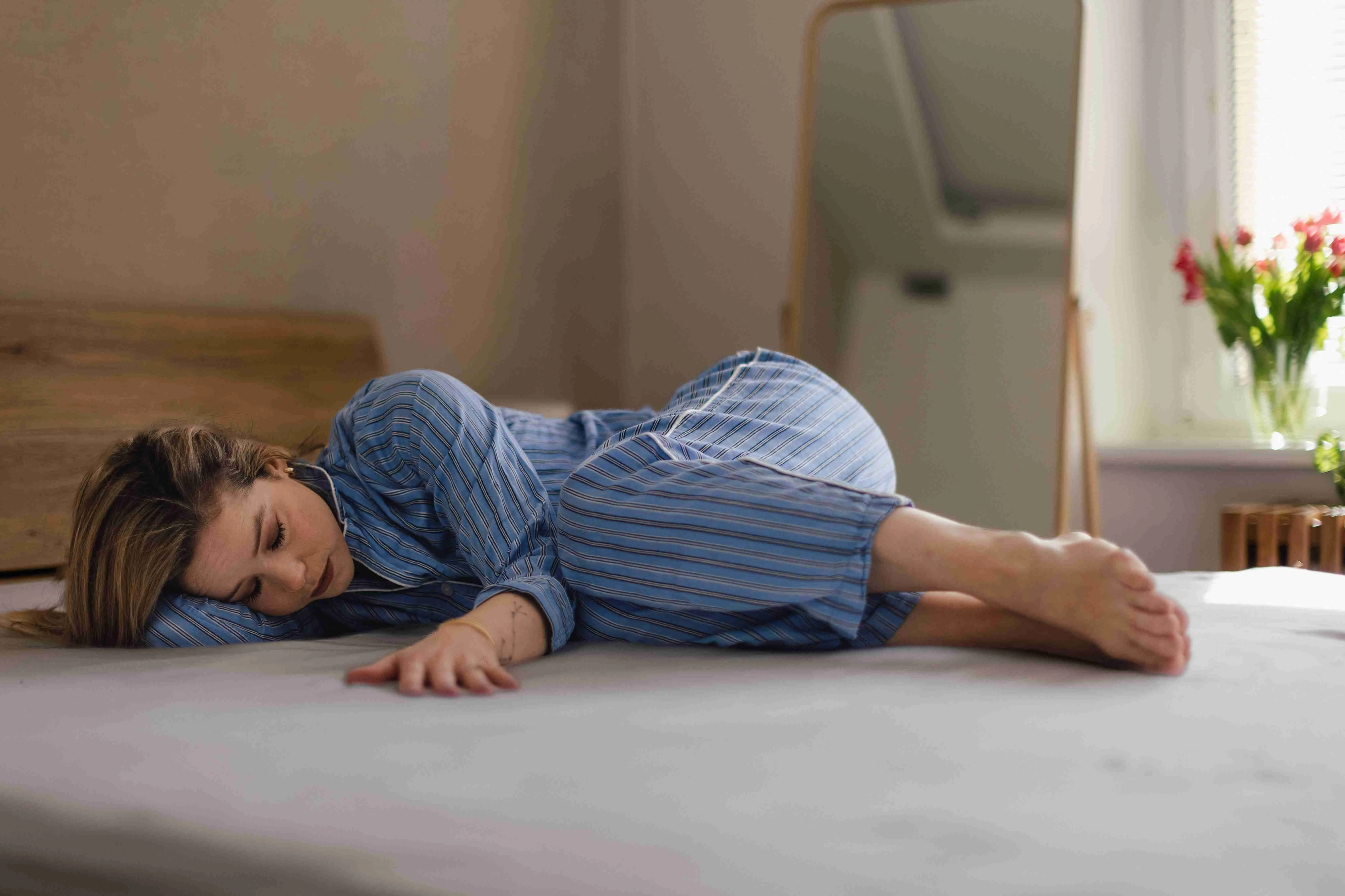 Young woman lying alone in a bed